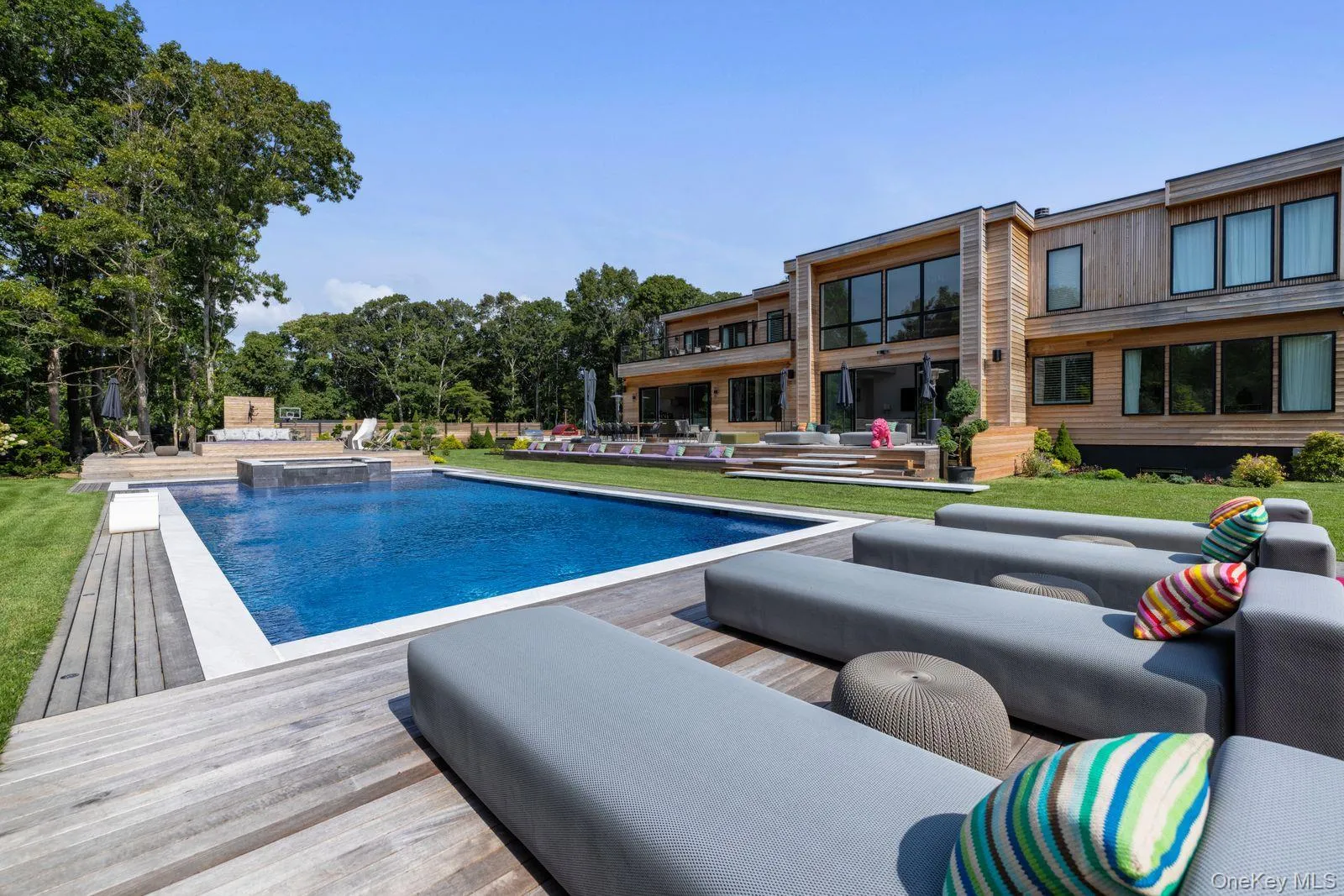 View of pool with a patio area, an outdoor living space, a pool with connected hot tub, and a deck View of pool with a patio area, an outdoor living space, a pool with connected hot tub, and a deck