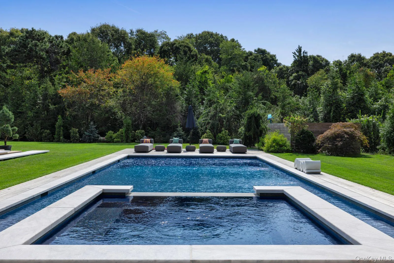 View of pool featuring a yard and a pool with connected hot tub View of pool featuring a yard and a pool with connected hot tub