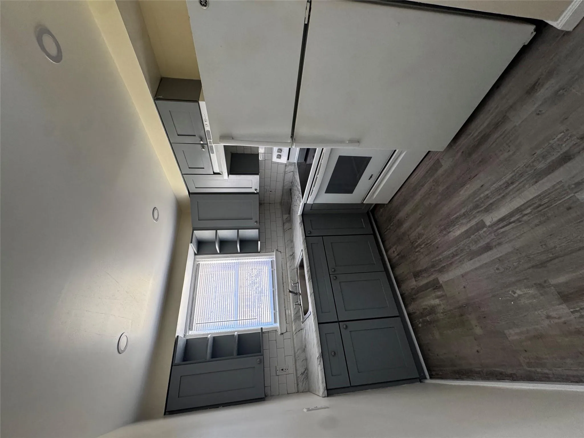 Kitchen featuring gray cabinets, open shelves, fridge, and range Kitchen featuring gray cabinets, open shelves, fridge, and range