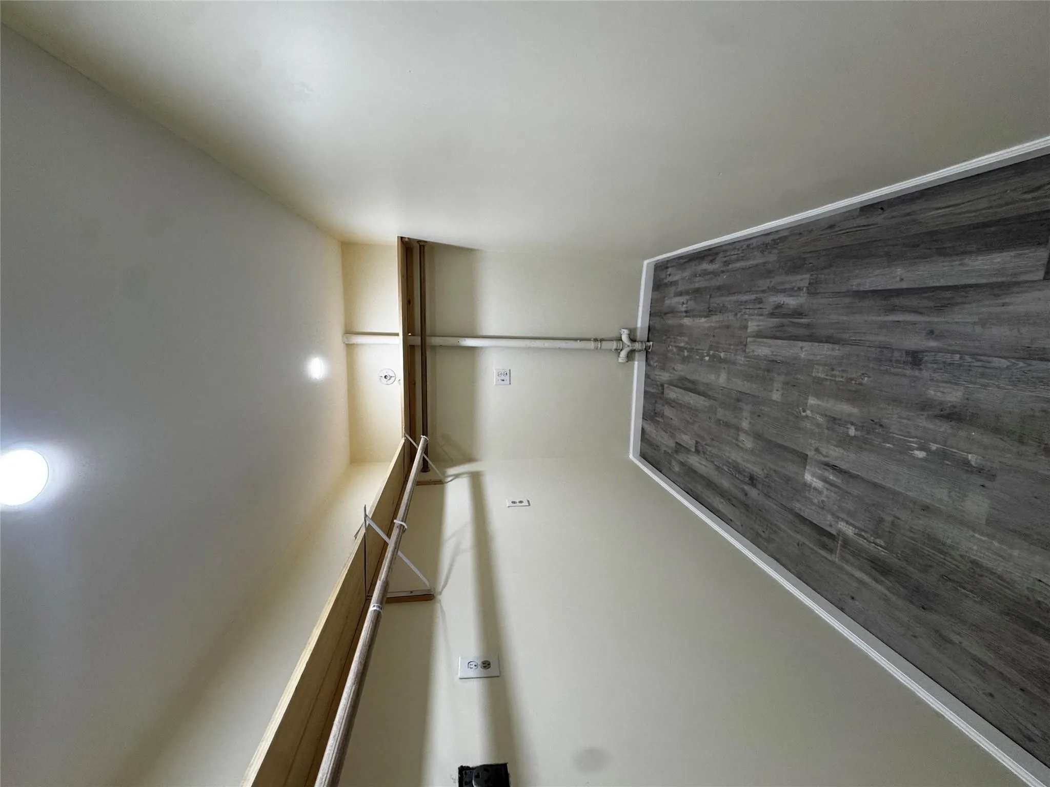 Spacious closet with dark wood finished floors Spacious closet with dark wood finished floors