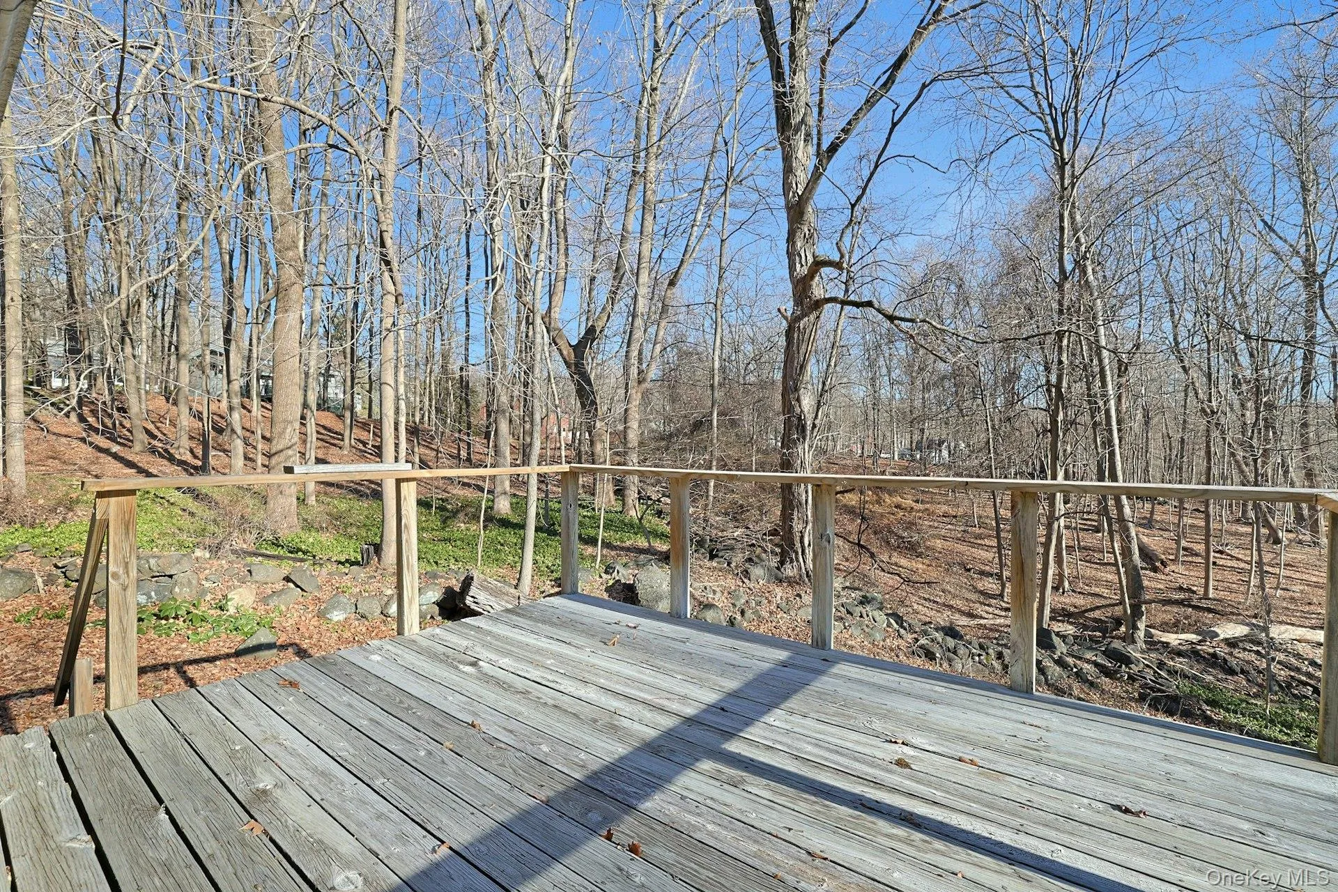 Off of the primary bedroom, this deck with stairs down to the yard overlooks the woods beyond. Off of the primary bedroom, this deck with stairs down to the yard overlooks the woods beyond.