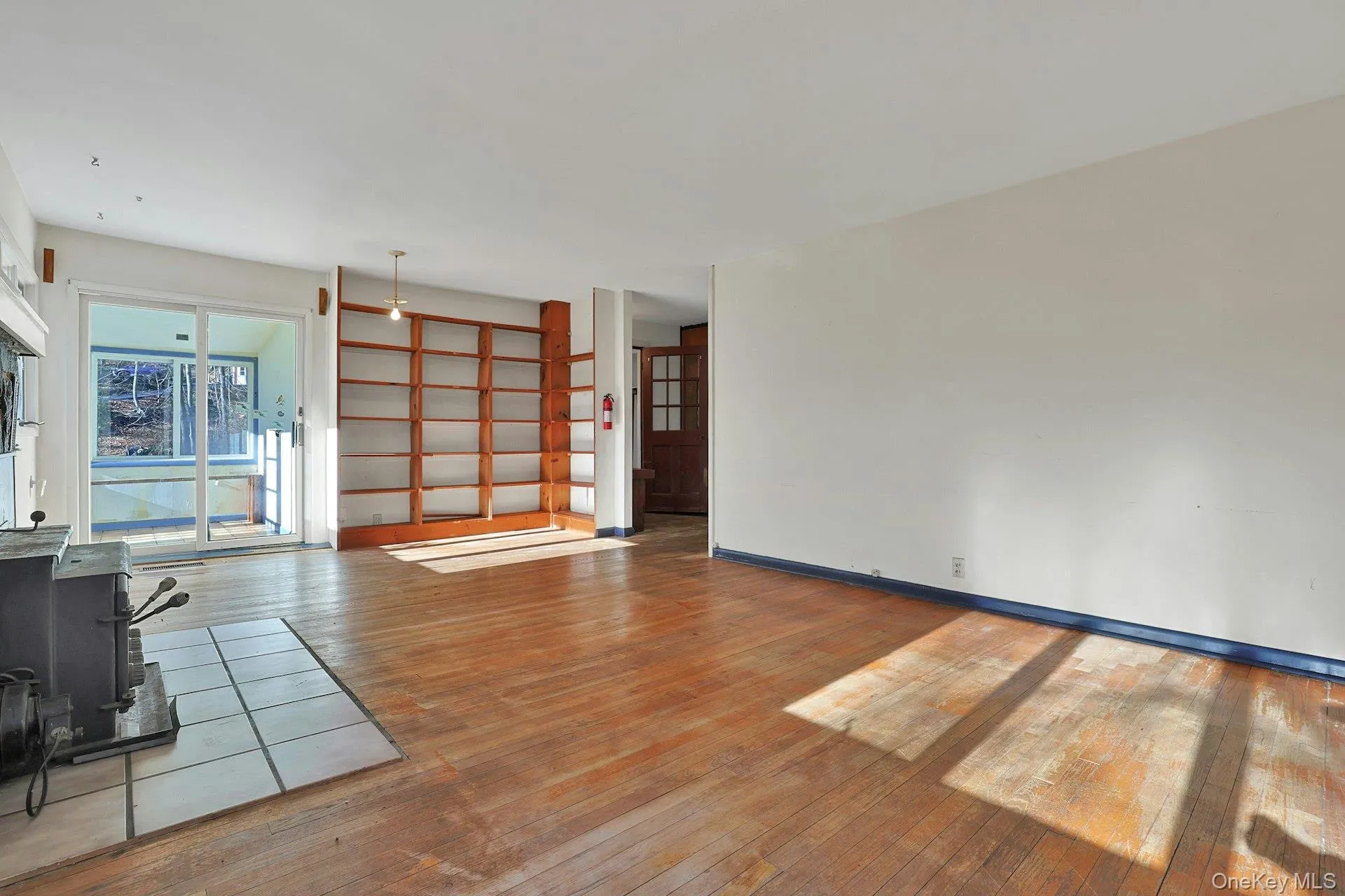What will be the first book that you place on these shelves? The doorway opens to the central hall and kitchen beyond. What will be the first book that you place on these shelves? The doorway opens to the central hall and kitchen beyond.