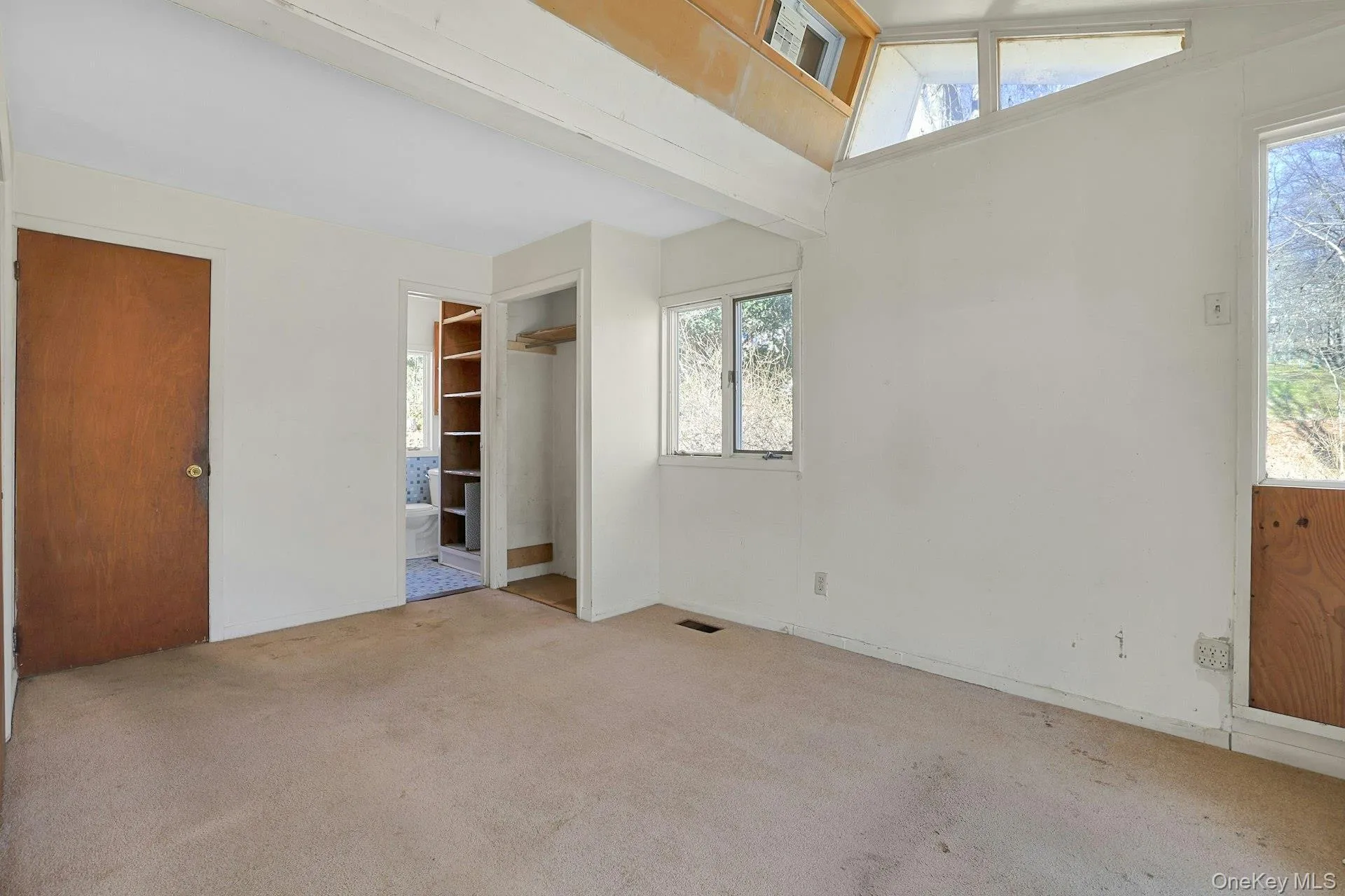 The vaulted ceiling in the primary bedroom brings in much light and an airy feeling. The vaulted ceiling in the primary bedroom brings in much light and an airy feeling.
