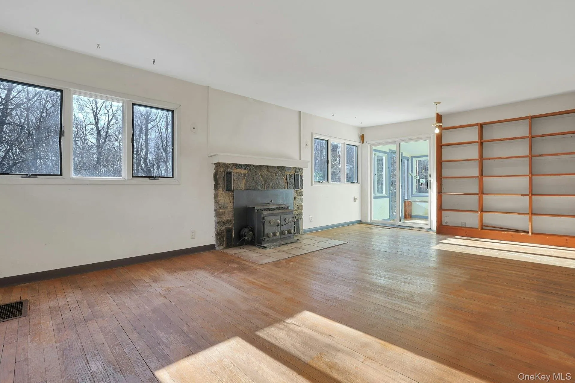 The natural light from the many windows gleams off of the wood floors in this expansive room. The natural light from the many windows gleams off of the wood floors in this expansive room.