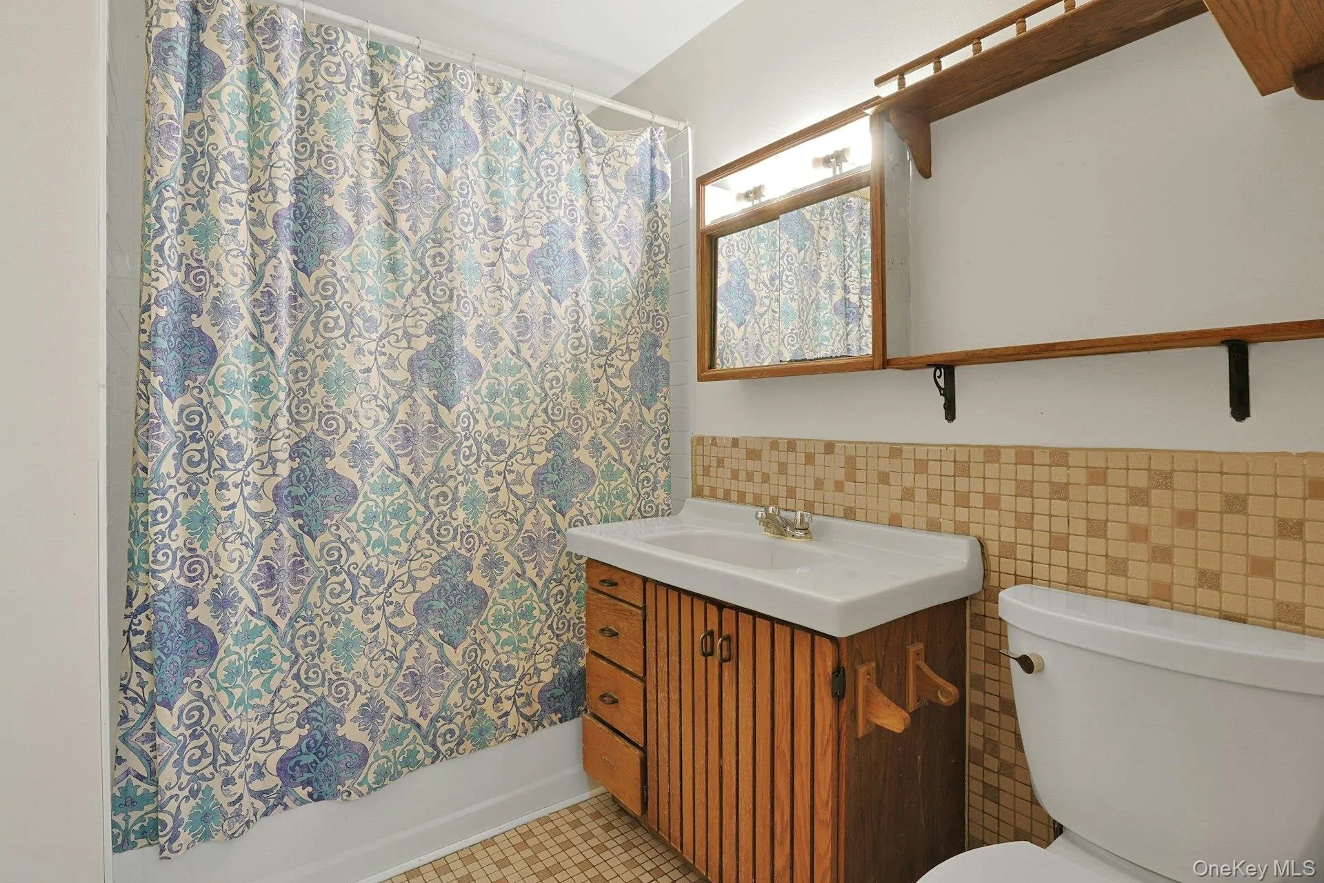 The hall bathroom features a tub and shower with a tile surround. The hall bathroom features a tub and shower with a tile surround.