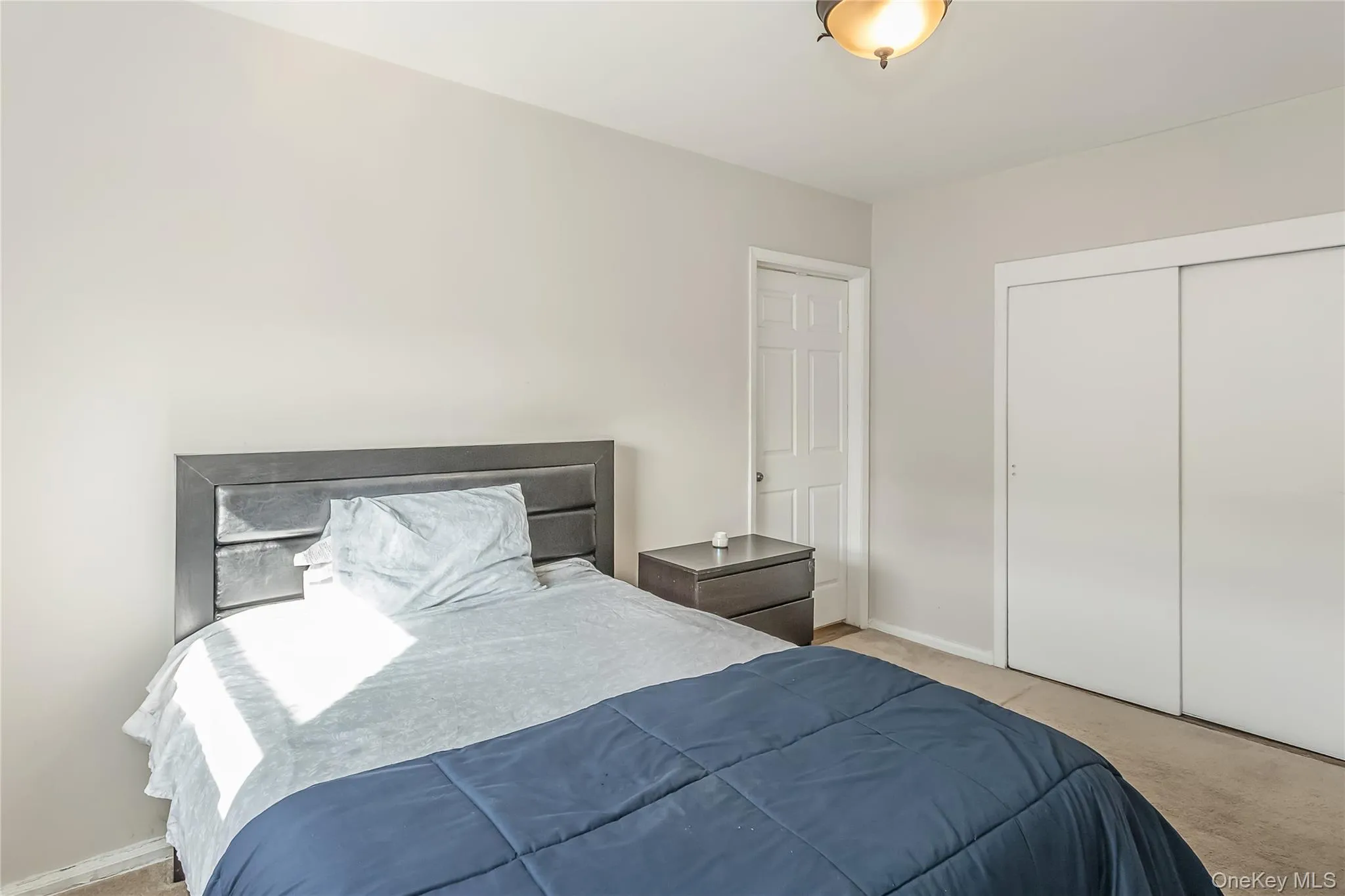 Bedroom with a closet, baseboards, and carpet Bedroom with a closet, baseboards, and carpet
