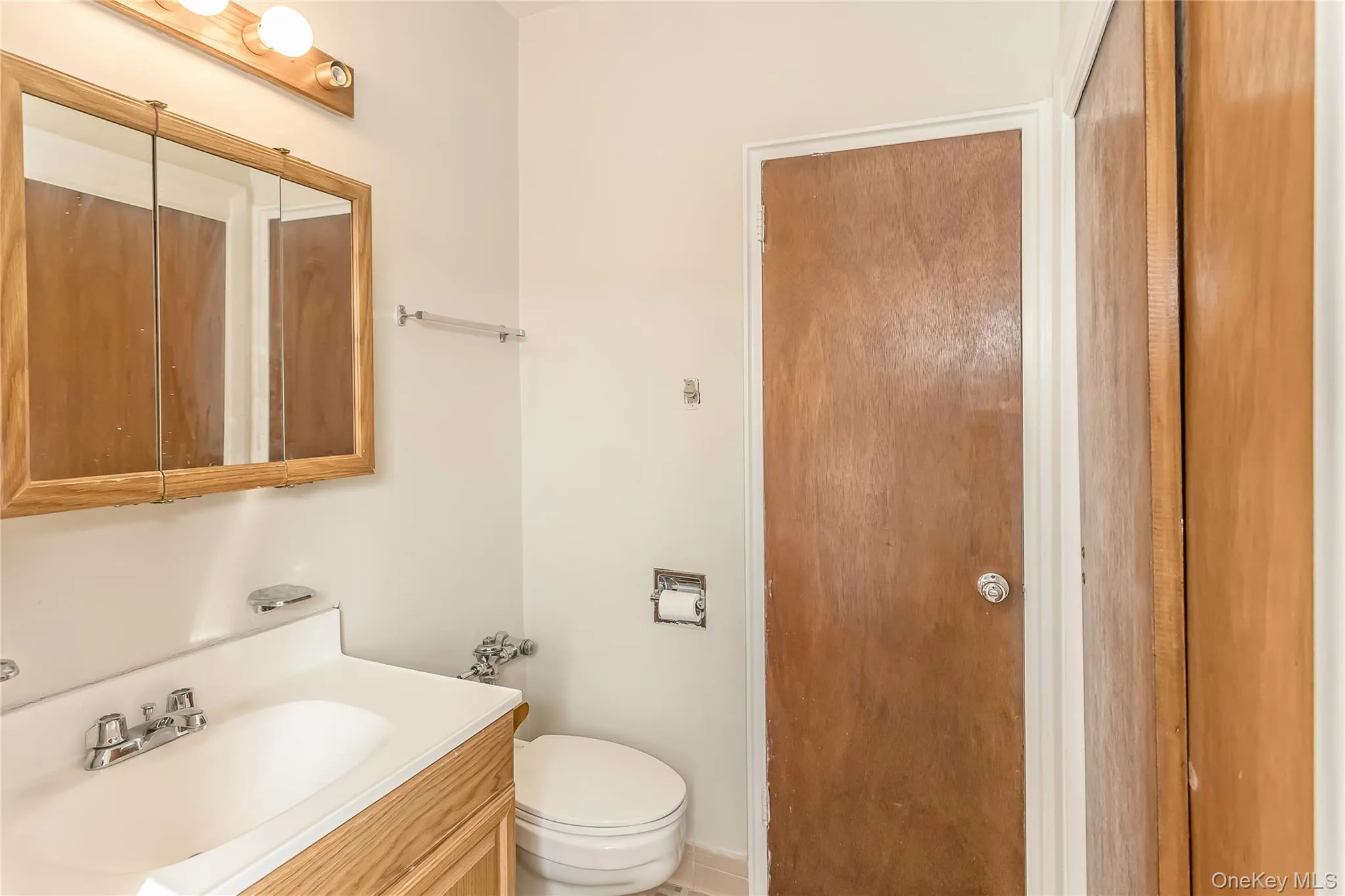 Half bathroom with toilet and vanity Half bathroom with toilet and vanity