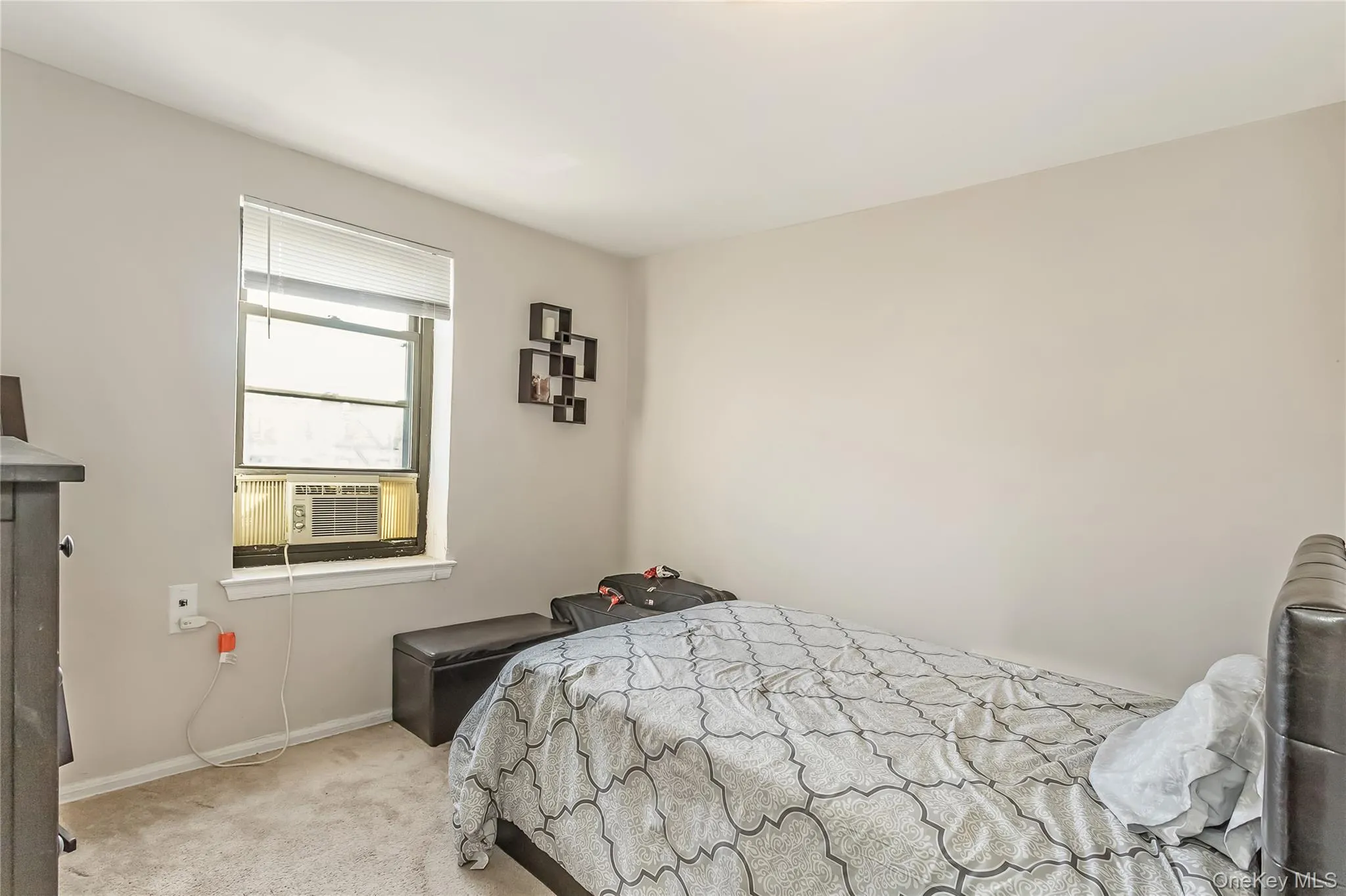Carpeted bedroom featuring cooling unit and baseboards Carpeted bedroom featuring cooling unit and baseboards