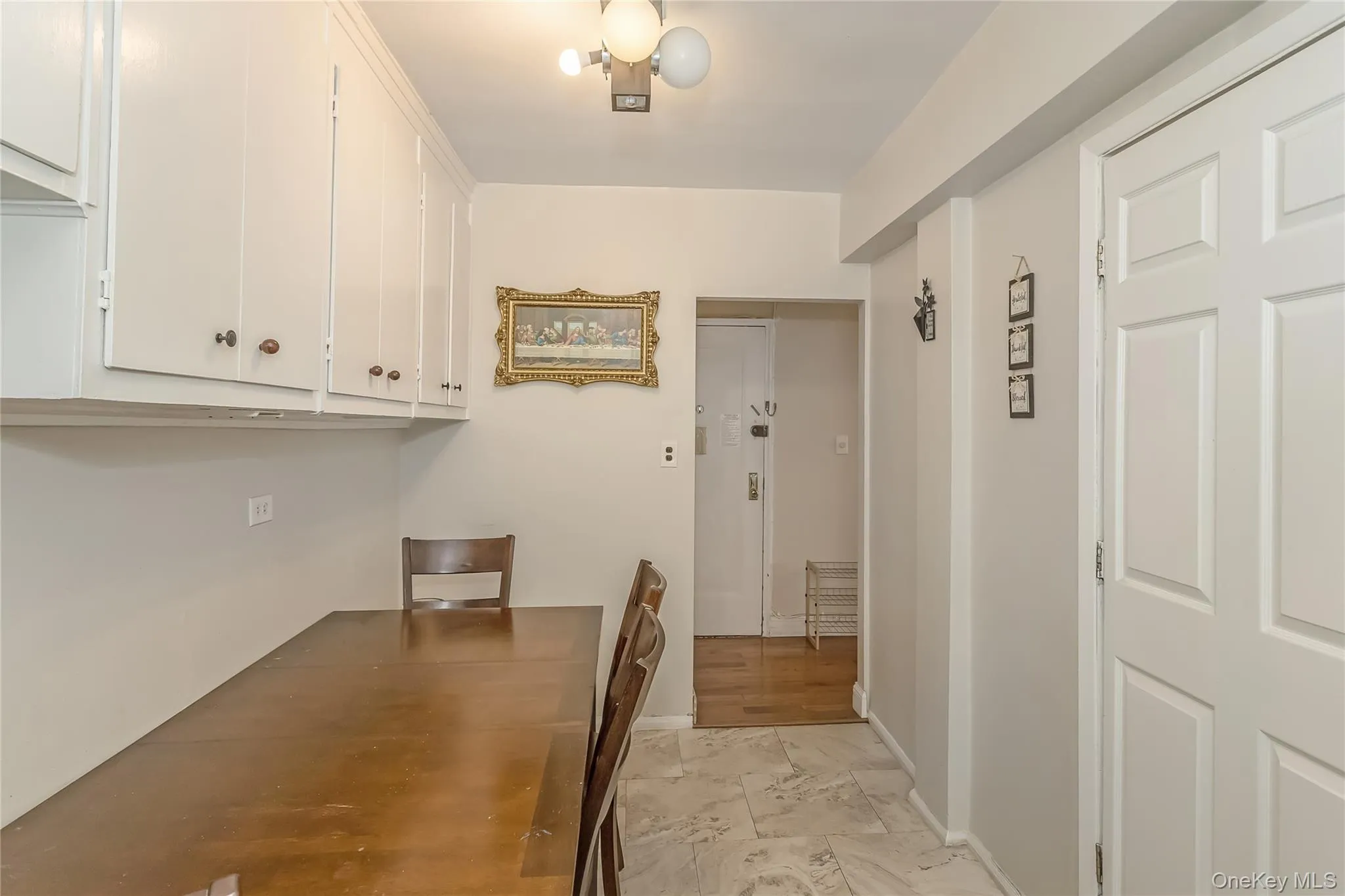 Unfurnished dining area with marble finish floor and baseboards Unfurnished dining area with marble finish floor and baseboards