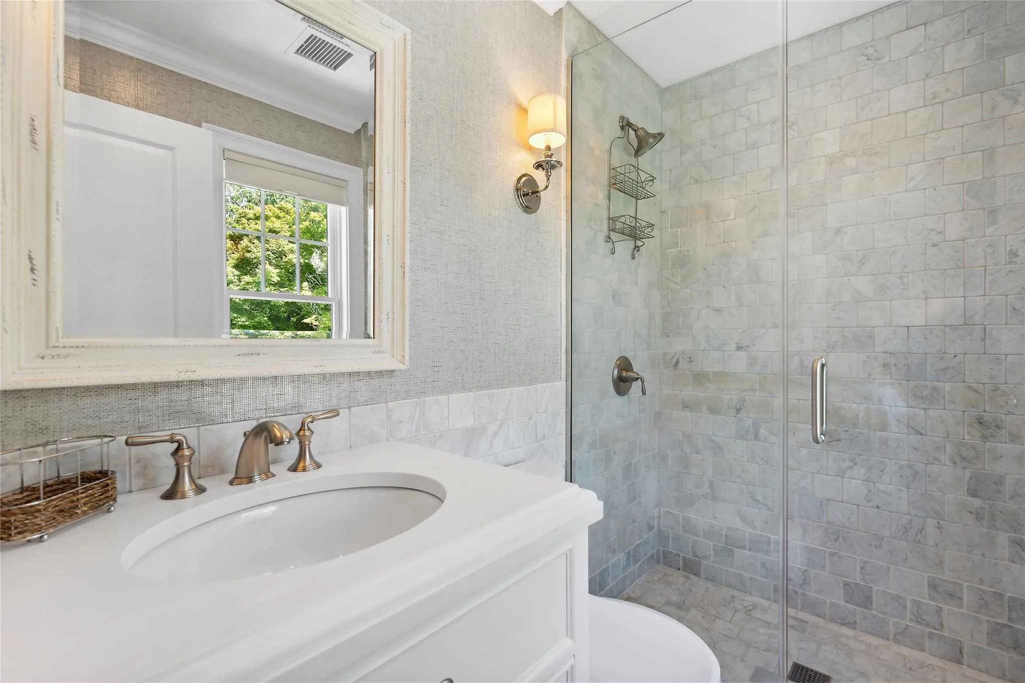 Bathroom featuring visible vents, vanity, a shower stall, and toilet Bathroom featuring visible vents, vanity, a shower stall, and toilet