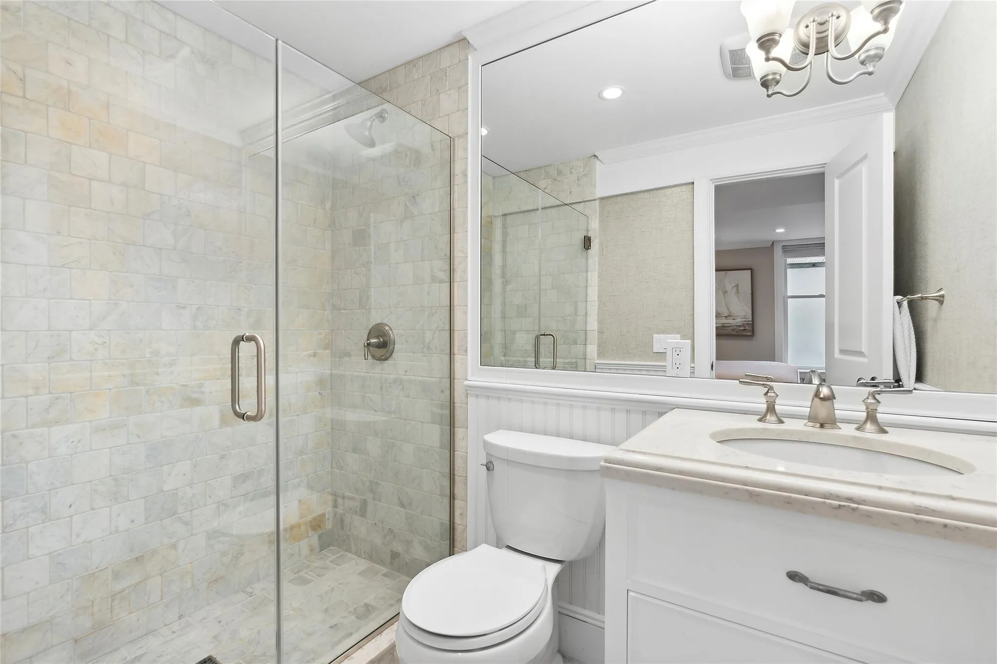 Full bathroom featuring toilet, a stall shower, vanity, and ornamental molding Full bathroom featuring toilet, a stall shower, vanity, and ornamental molding