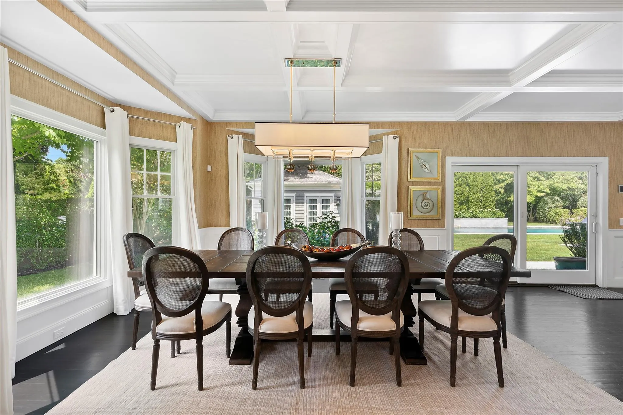 Dining space with beam ceiling, ornamental molding, coffered ceiling, and wood finished floors Dining space with beam ceiling, ornamental molding, coffered ceiling, and wood finished floors