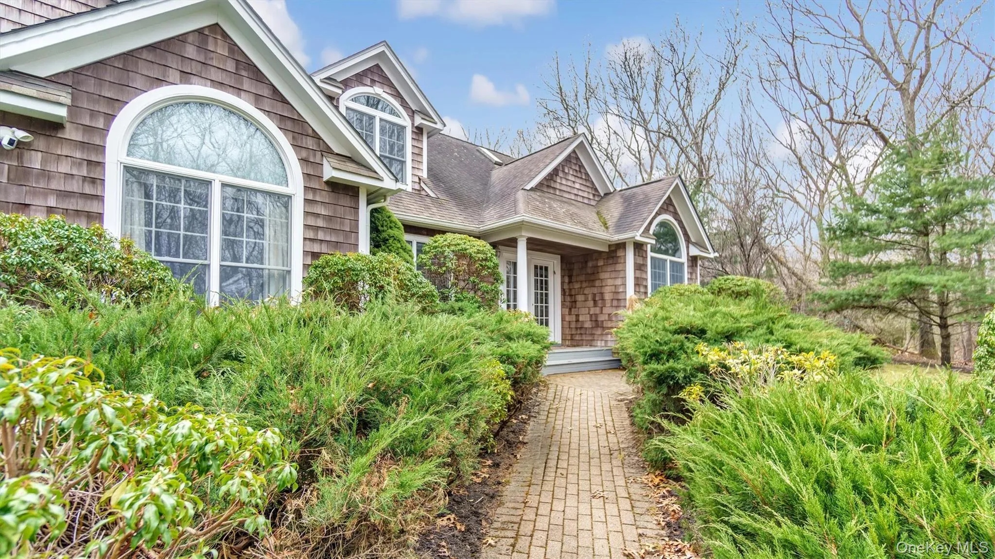 Entrance to property featuring a shingled roof Entrance to property featuring a shingled roof