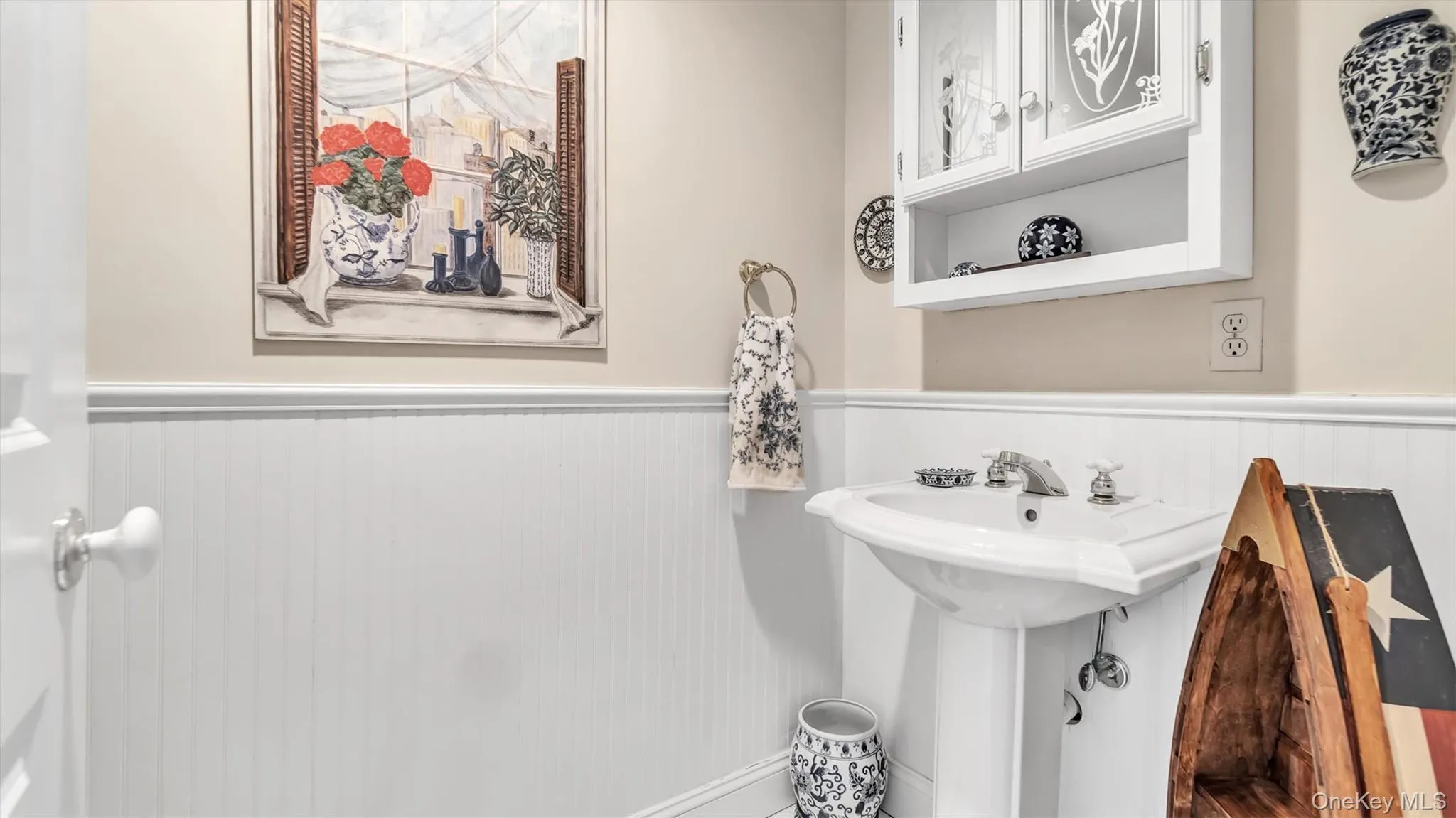 Bathroom featuring a sink and a wainscoted wall Bathroom featuring a sink and a wainscoted wall
