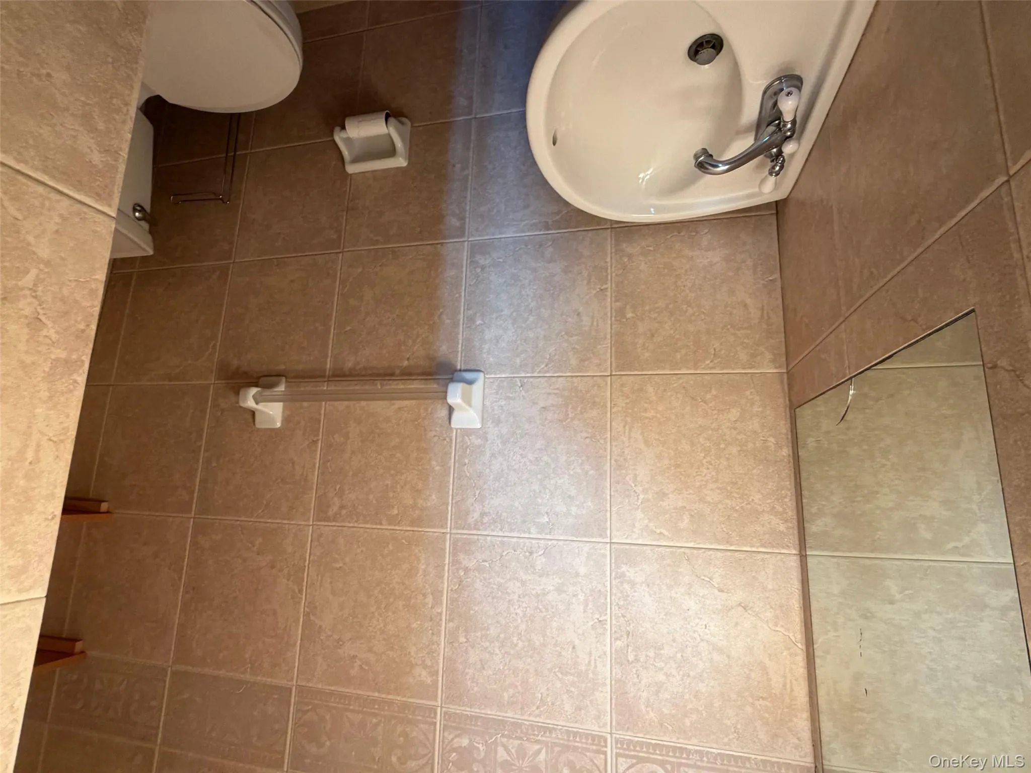 Half bathroom with tile walls Half bathroom with tile walls
