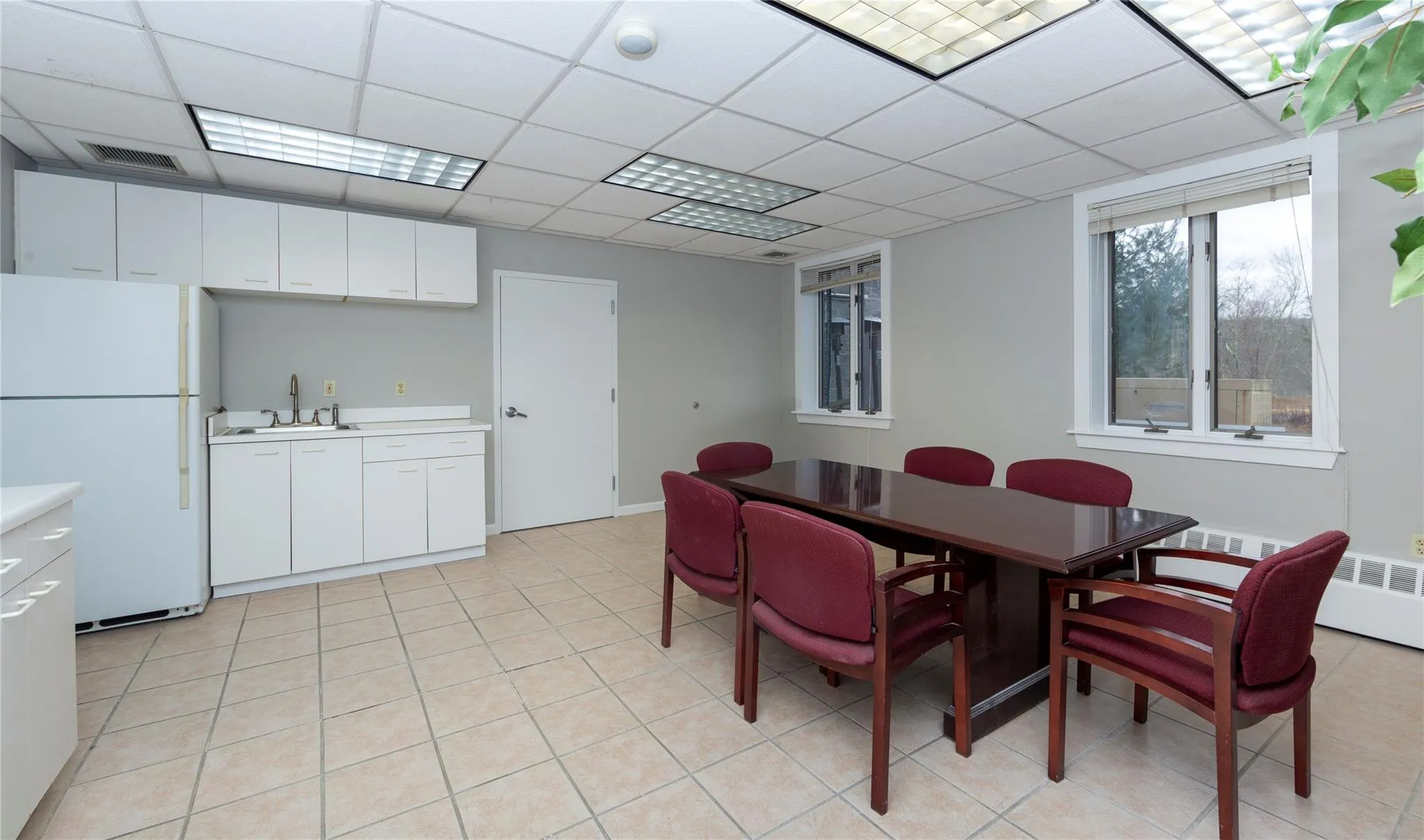 Dining area with light tile patterned floors, visible vents, a paneled ceiling, and radiator Dining area with light tile patterned floors, visible vents, a paneled ceiling, and radiator