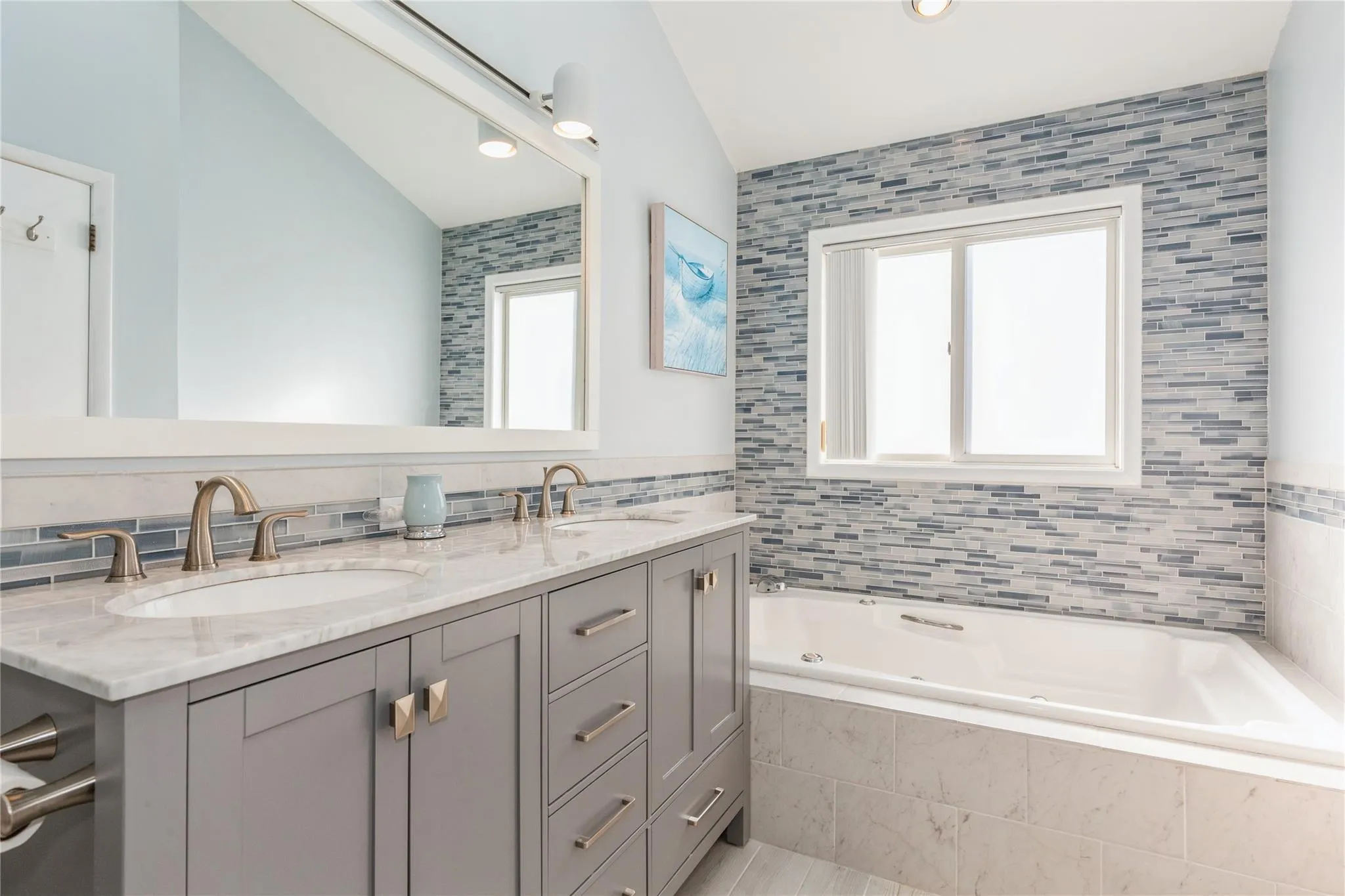 Full bath with double vanity, a jetted tub, and a sink Full bath with double vanity, a jetted tub, and a sink