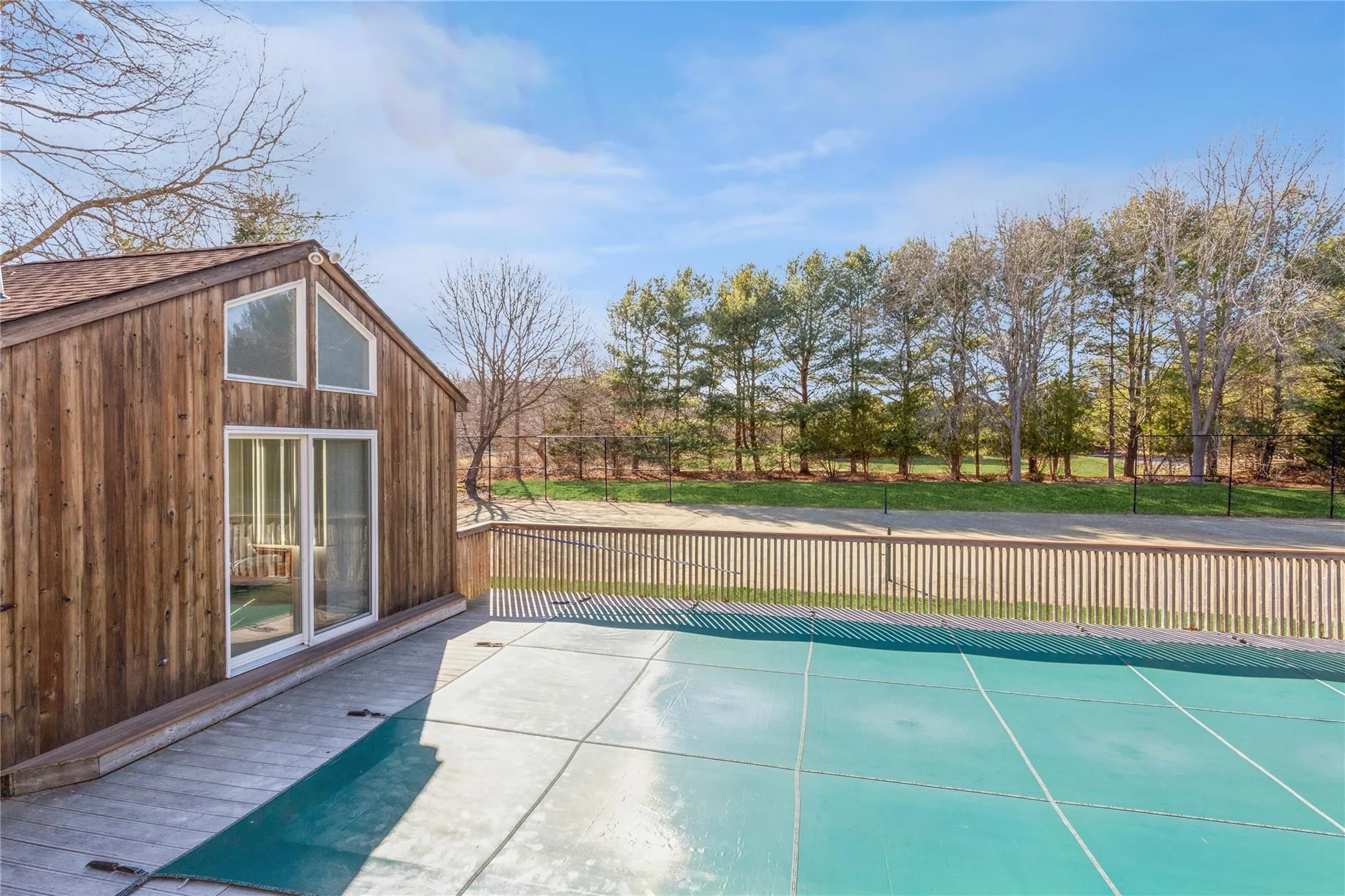 View of swimming pool with fence View of swimming pool with fence