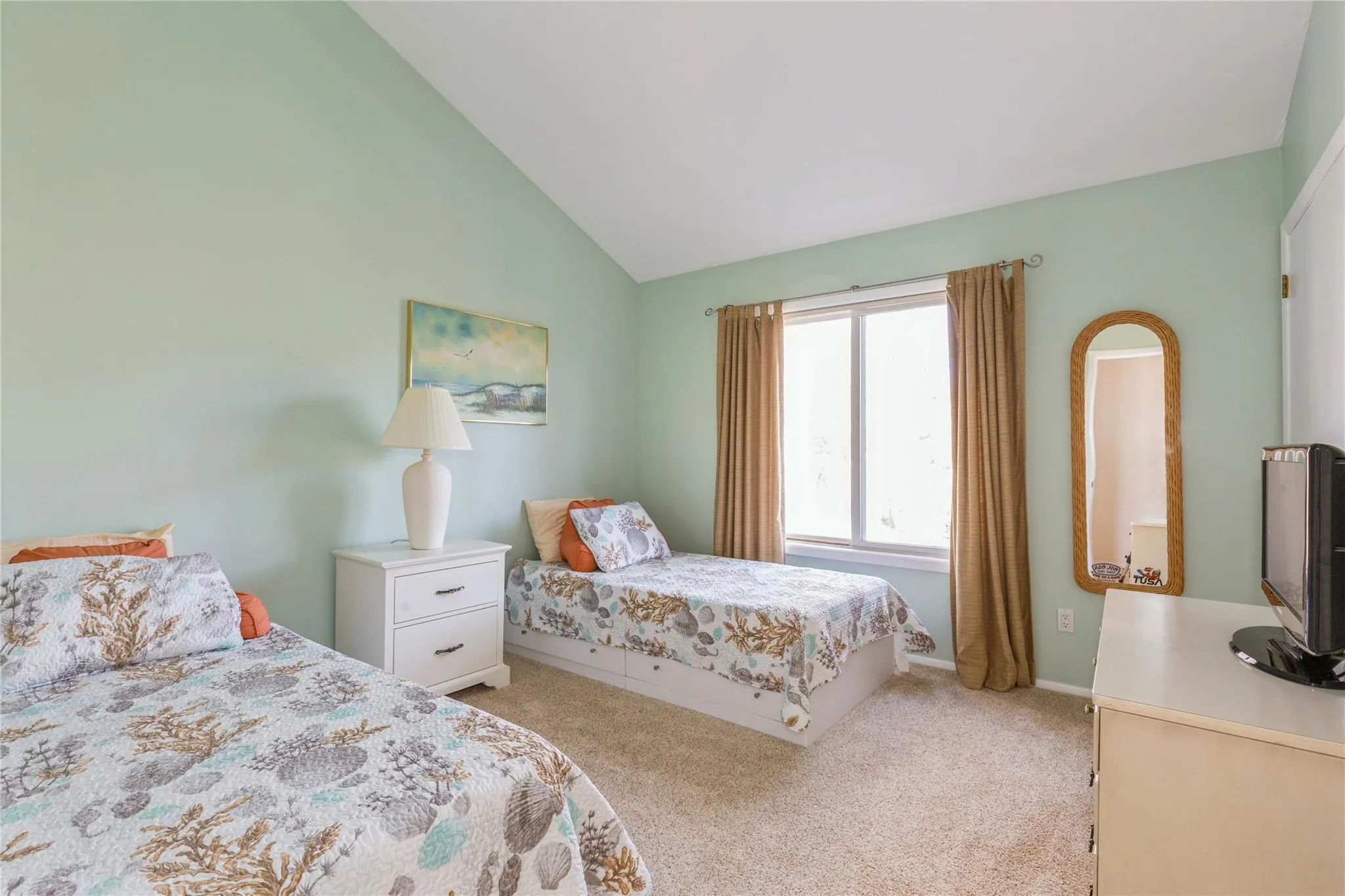 Bedroom with lofted ceiling and light carpet Bedroom with lofted ceiling and light carpet