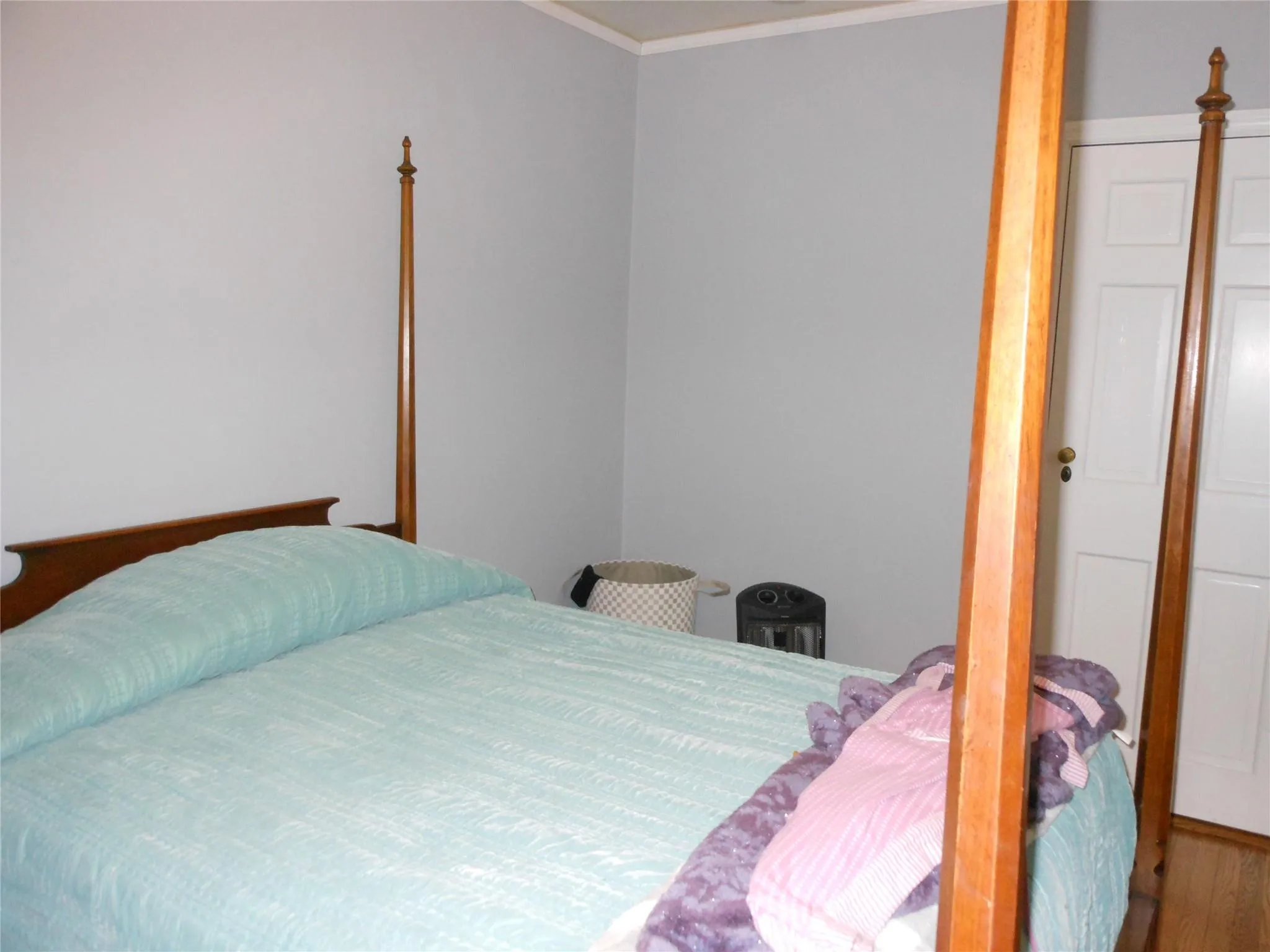 Bedroom with wood finished floors and crown molding Bedroom with wood finished floors and crown molding