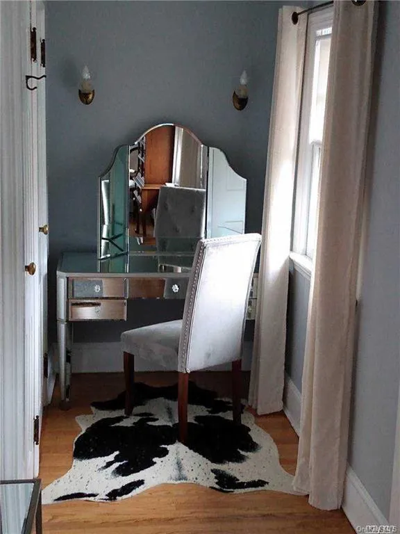Bedroom featuring baseboards and light wood-style floors Bedroom featuring baseboards and light wood-style floors