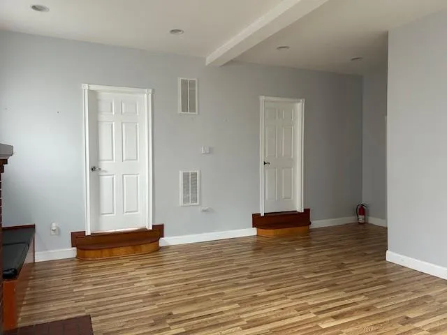 Unfurnished Open Space featuring wood floors, windows and 2 separate office doors Unfurnished Open Space featuring wood floors, windows and 2 separate office doors