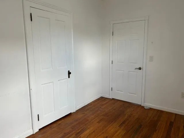 Unfurnished Office featuring wood floors with 2 separate doors Unfurnished Office featuring wood floors with 2 separate doors