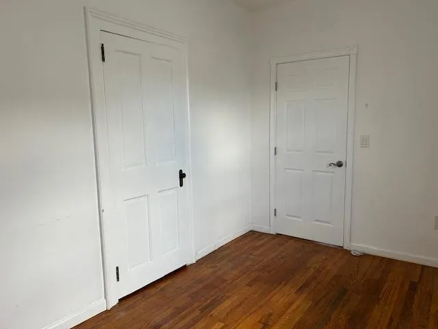 Unfurnished Office featuring wood floors with 2 separate doors Unfurnished Office featuring wood floors with 2 separate doors