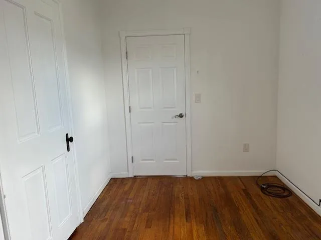 Unfurnished Office featuring wood floors and 2 separate doors Unfurnished Office featuring wood floors and 2 separate doors