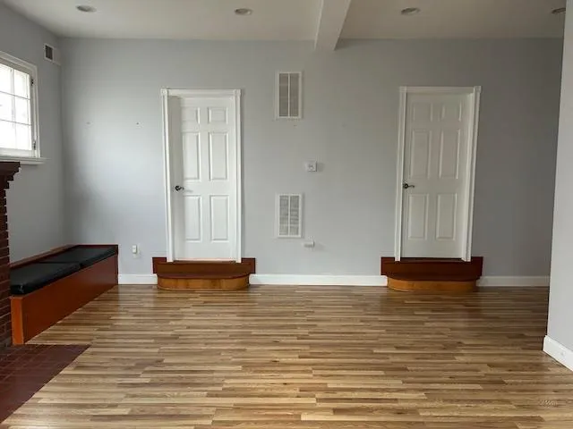 Unfurnished Open Space featuring wood floors, windows and 2 separate office doors Unfurnished Open Space featuring wood floors, windows and 2 separate office doors