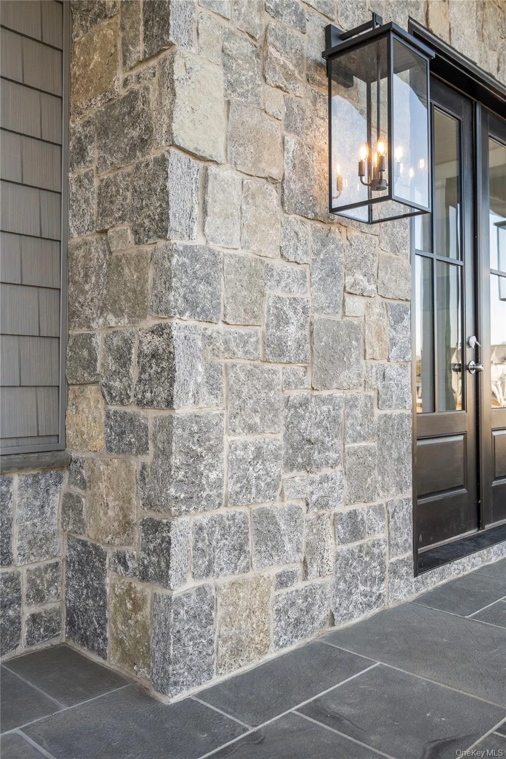 Property entrance featuring french doors and stone siding Property entrance featuring french doors and stone siding