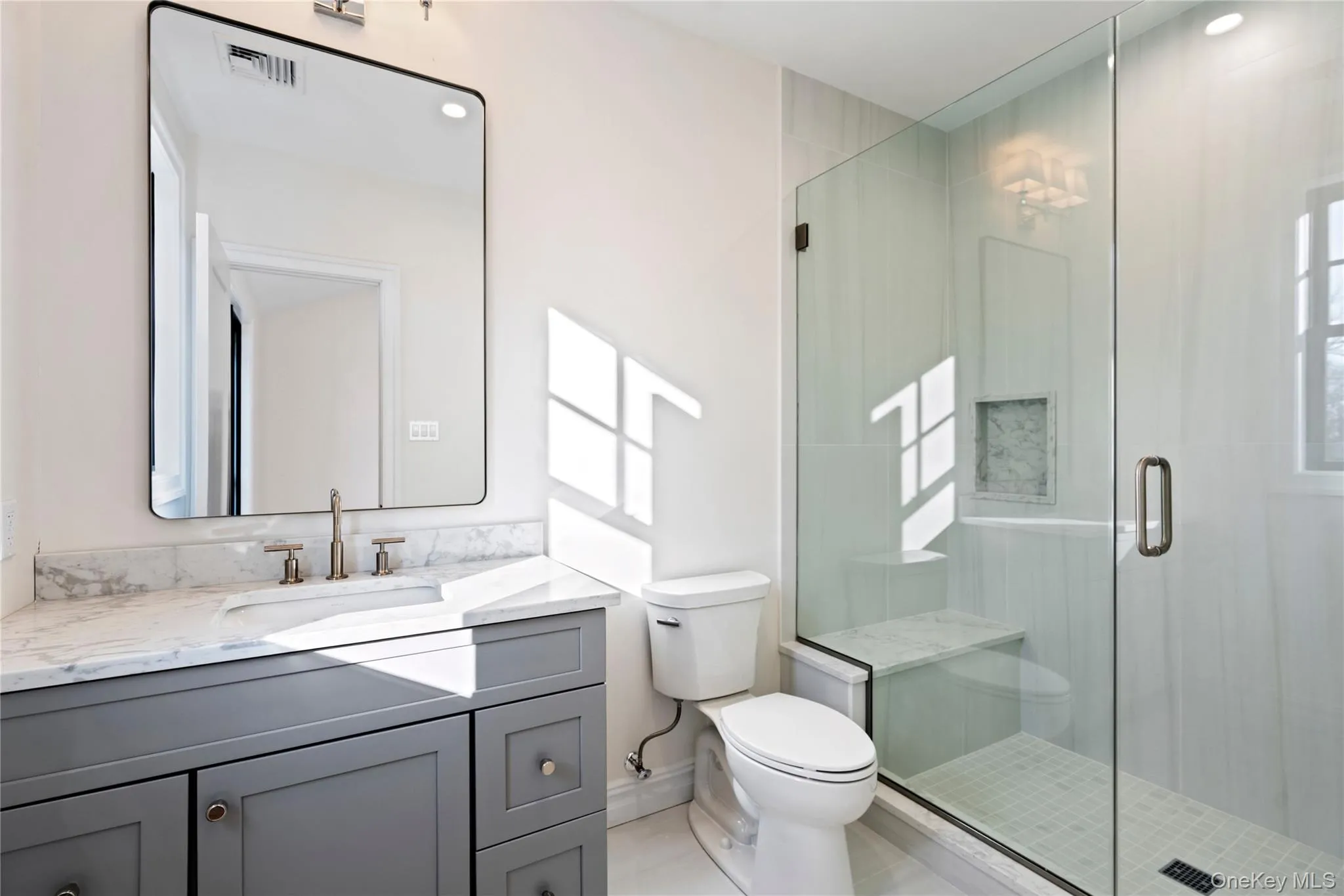 Full bath featuring vanity, a shower stall, and recessed lighting Full bath featuring vanity, a shower stall, and recessed lighting