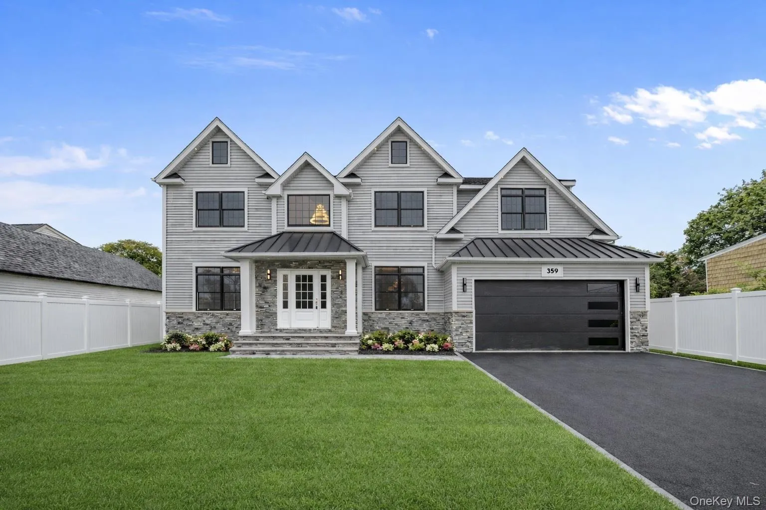 View of front of house featuring a standing seam roof, stone siding, and a metal roof View of front of house featuring a standing seam roof, stone siding, and a metal roof
