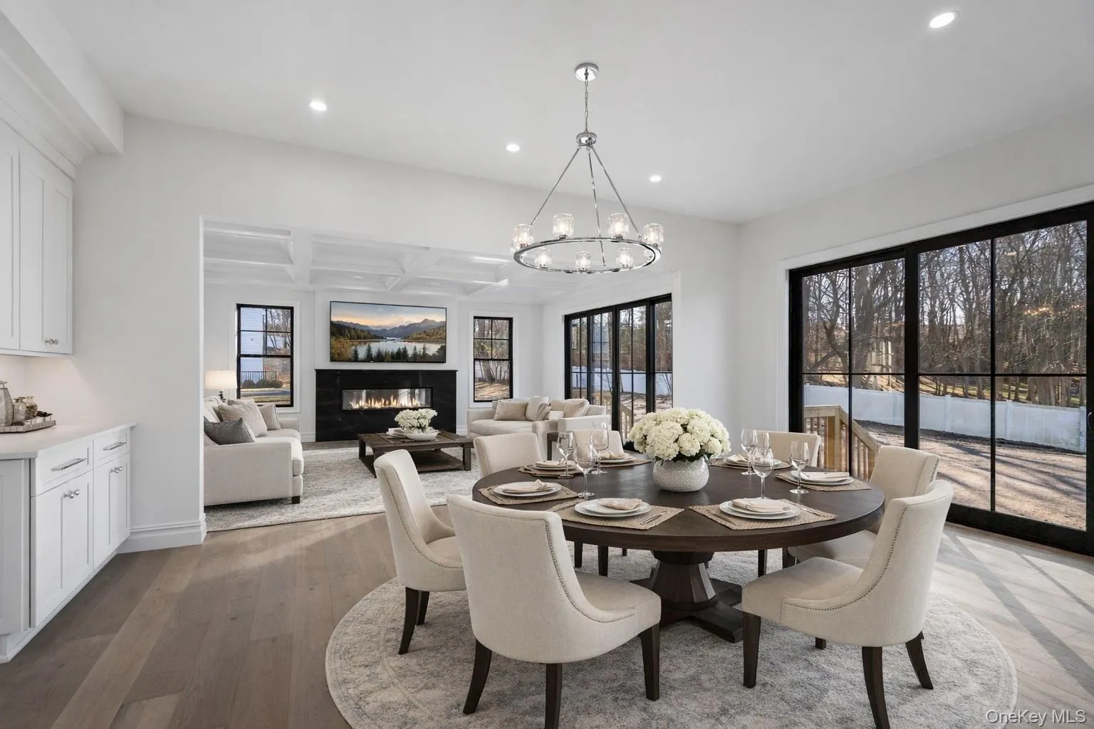 Dining room with coffered ceiling, a glass covered fireplace, recessed lighting, dark wood-type flooring, and beamed ceiling Dining room with coffered ceiling, a glass covered fireplace, recessed lighting, dark wood-type flooring, and beamed ceiling