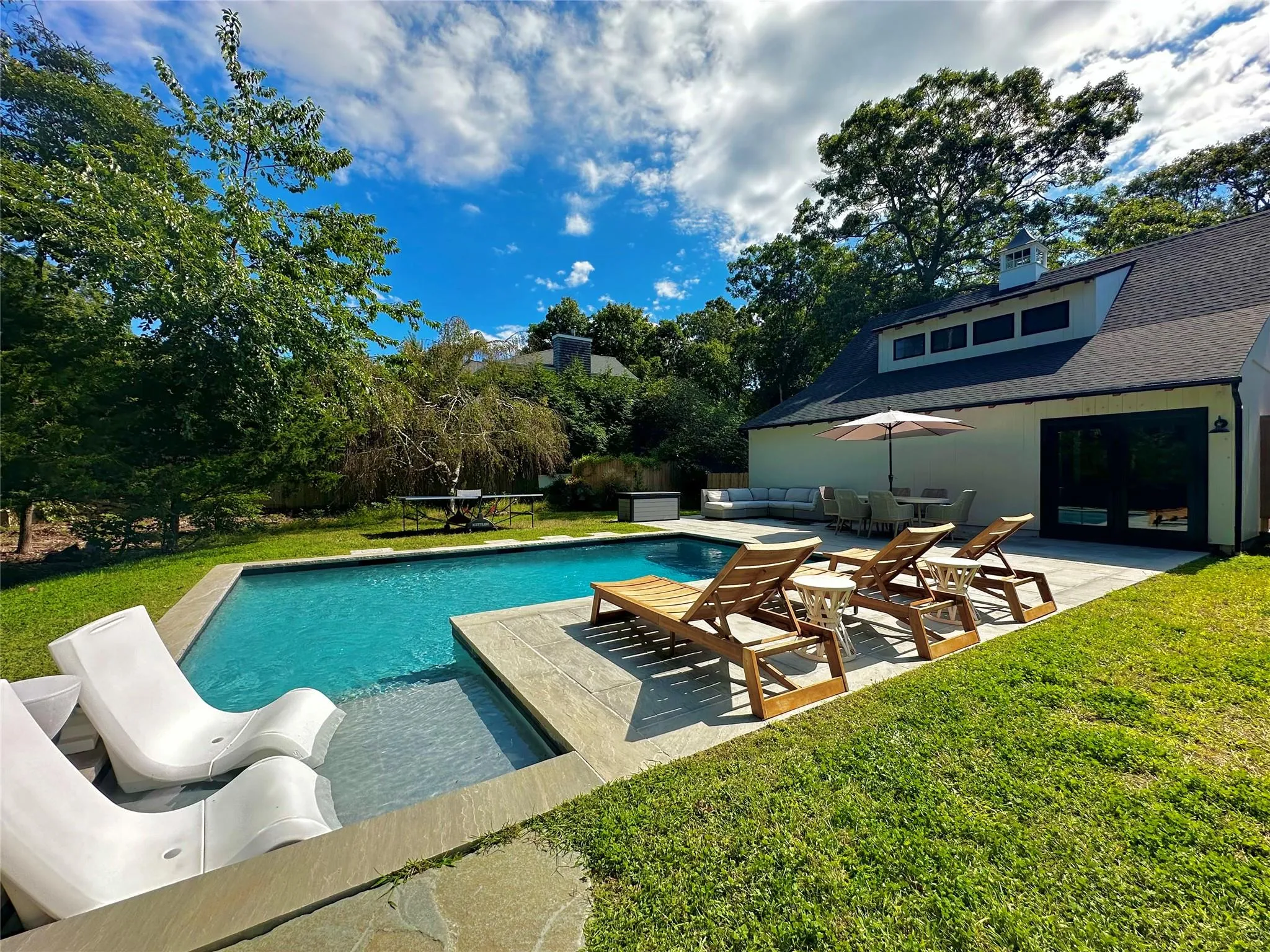 Pool featuring a patio, a lawn, and an outdoor living space Pool featuring a patio, a lawn, and an outdoor living space