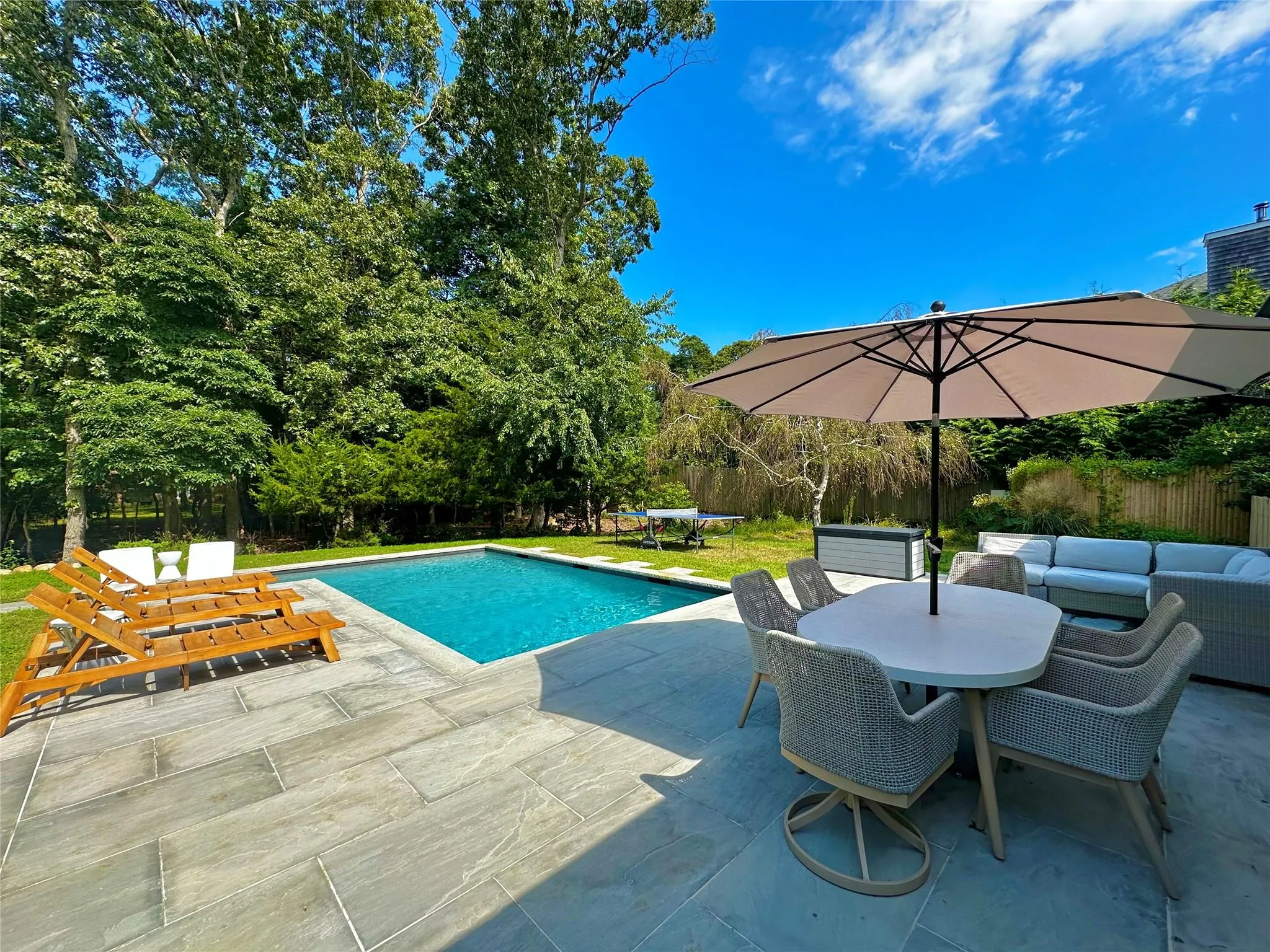 View of swimming pool with outdoor dining space, a patio, a fenced in pool, fence, and an outdoor hangout area View of swimming pool with outdoor dining space, a patio, a fenced in pool, fence, and an outdoor hangout area
