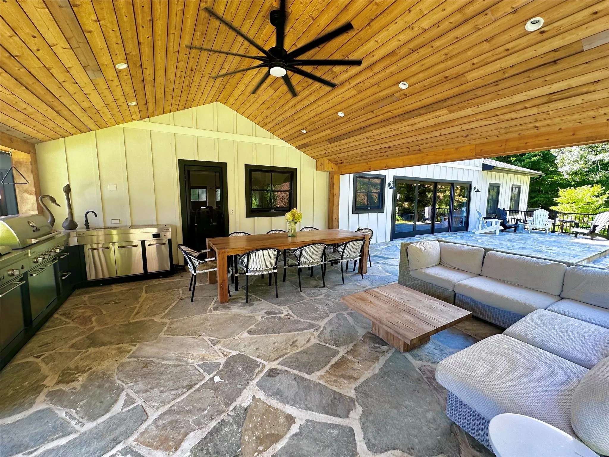 View of patio featuring an outdoor kitchen, an outdoor hangout area, outdoor dining area, and ceiling fan View of patio featuring an outdoor kitchen, an outdoor hangout area, outdoor dining area, and ceiling fan