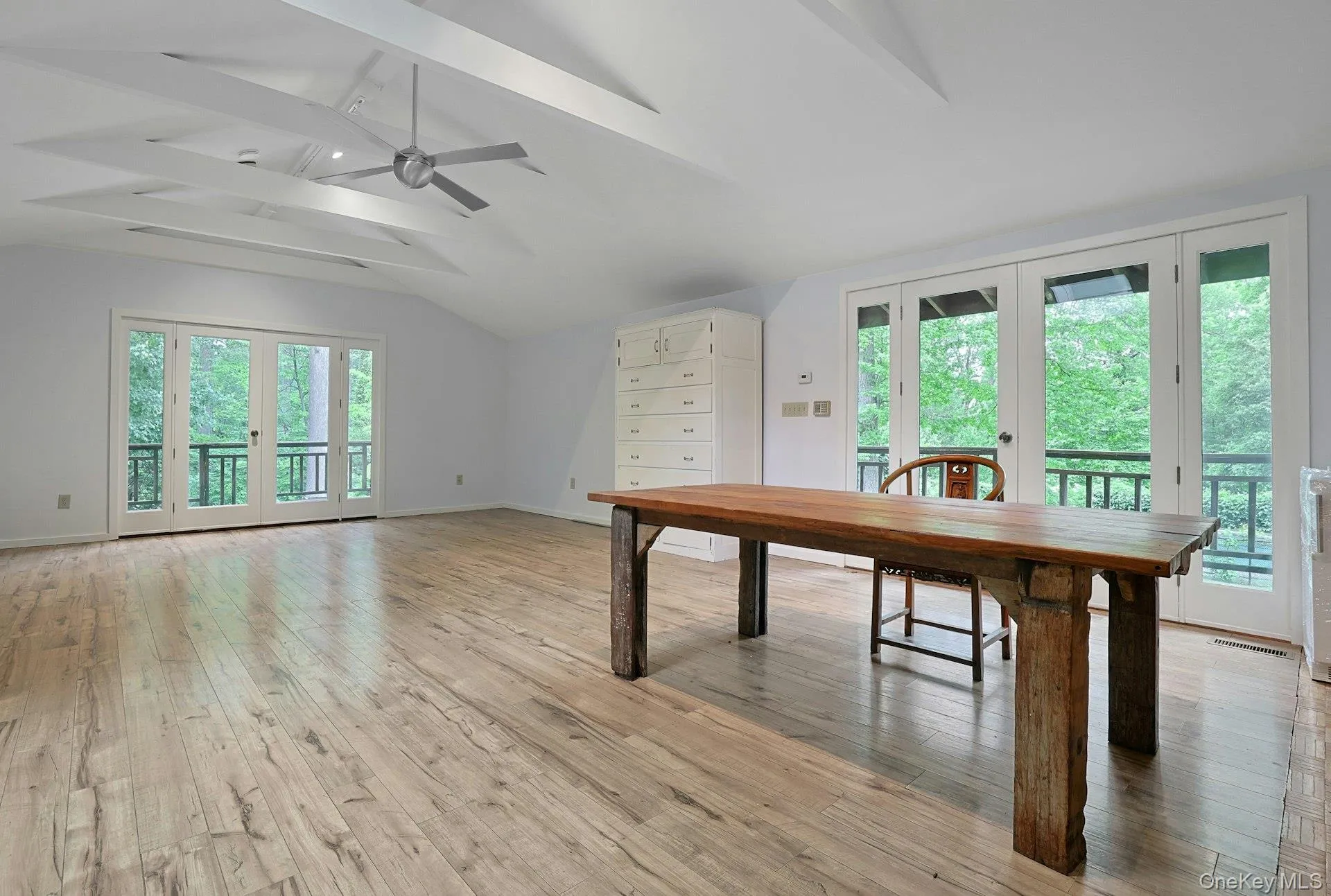 Dining space featuring light wood-style flooring, baseboards, french doors, and a ceiling fan Dining space featuring light wood-style flooring, baseboards, french doors, and a ceiling fan