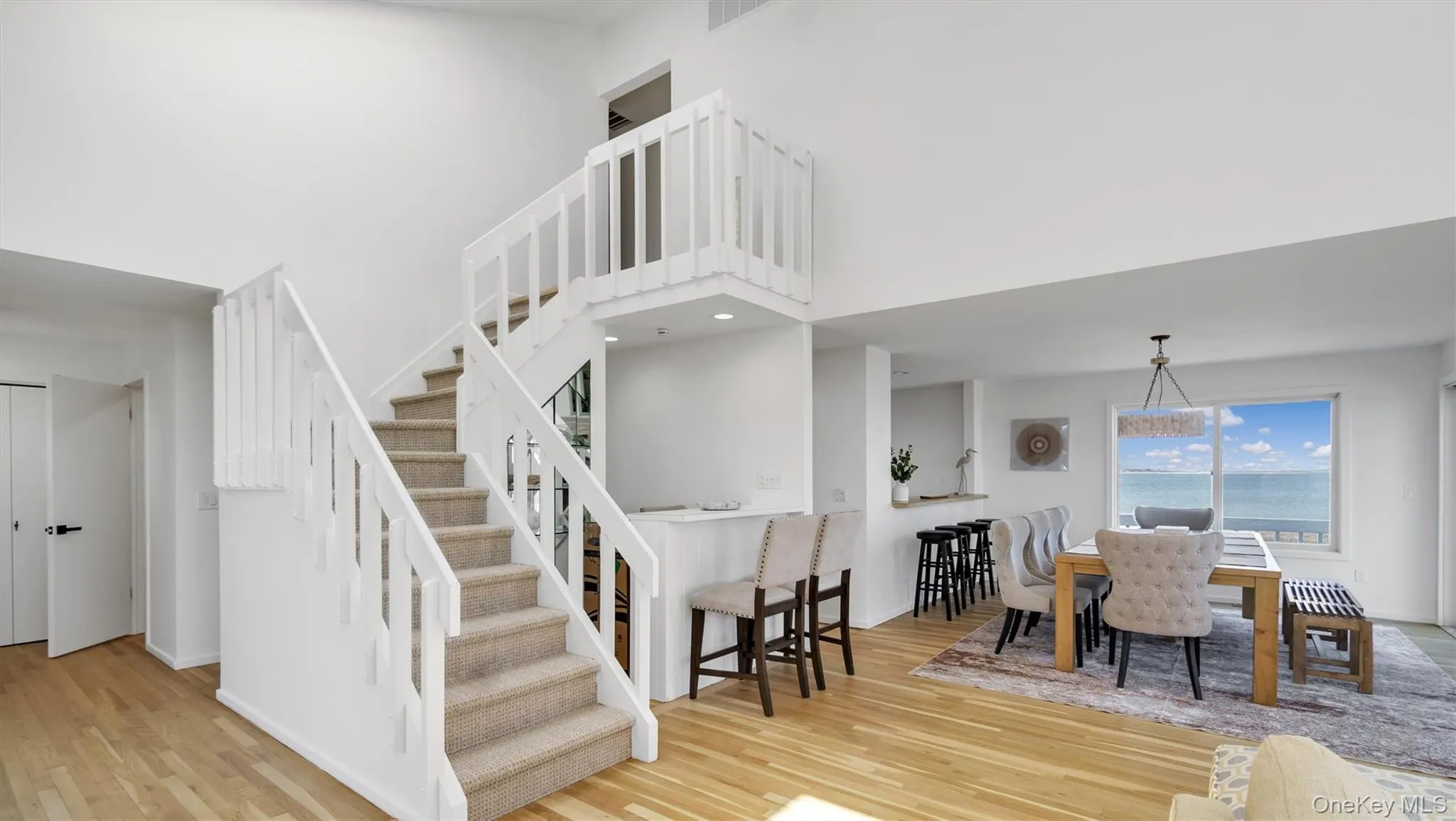 Staircase with a high ceiling, wood finished floors, and baseboards Staircase with a high ceiling, wood finished floors, and baseboards