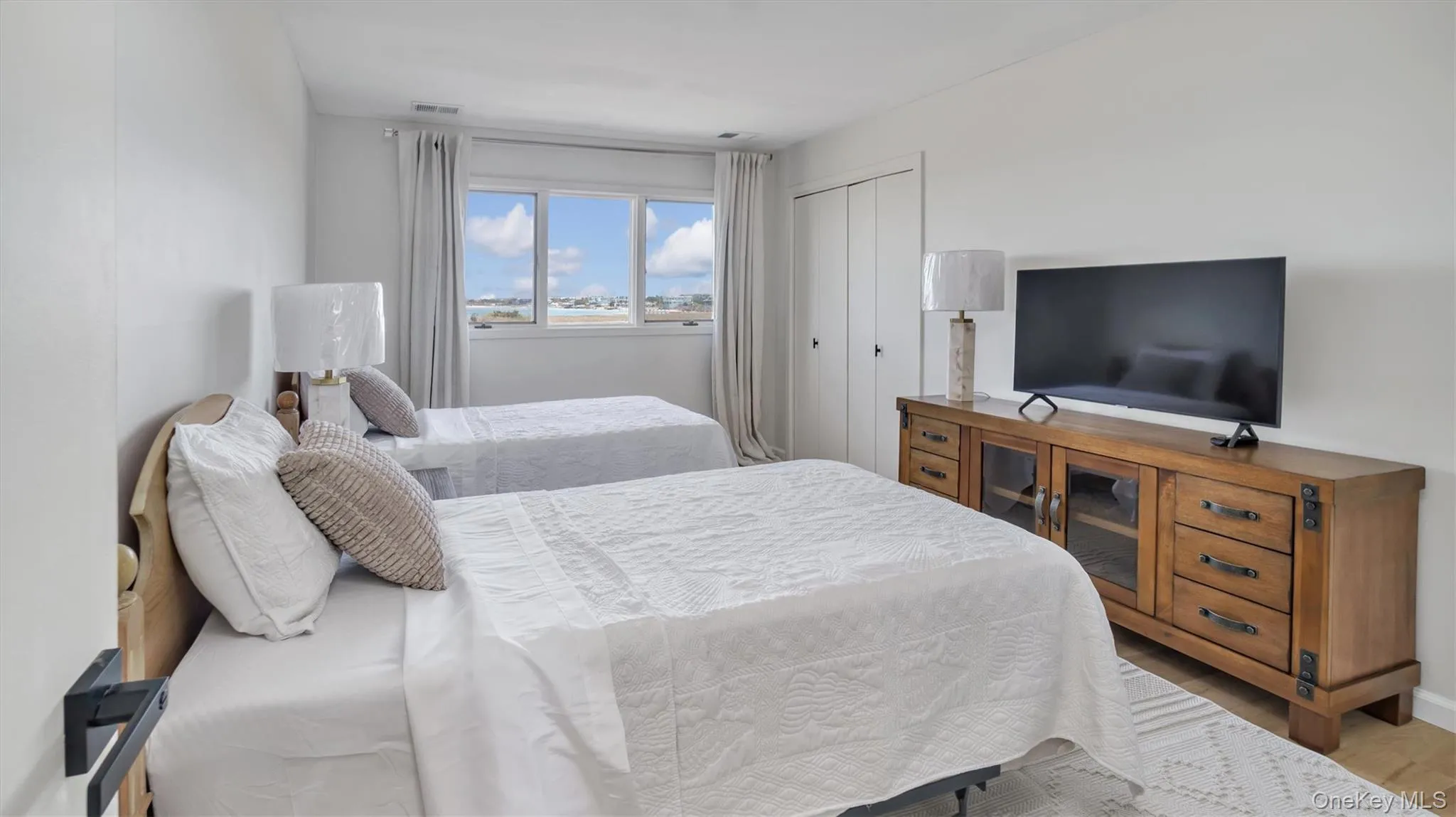 Bedroom with wood finished floors and a closet Bedroom with wood finished floors and a closet
