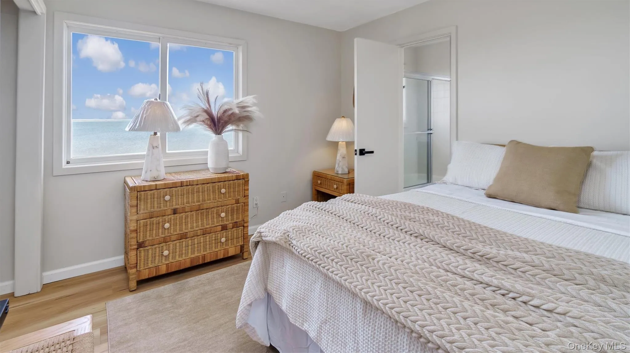 Bedroom featuring wood finished floors and baseboards Bedroom featuring wood finished floors and baseboards