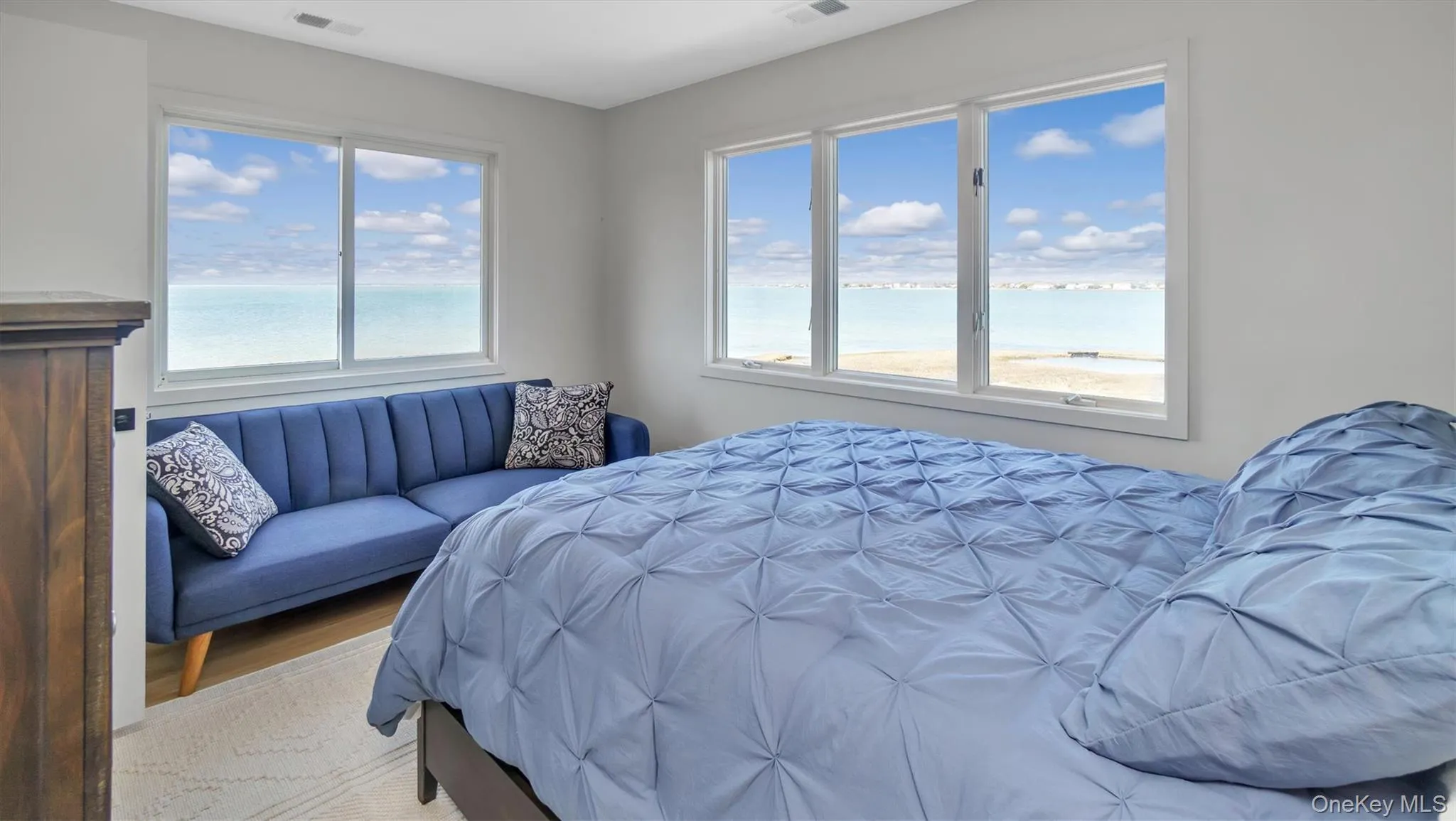 Bedroom featuring visible vents and a water view Bedroom featuring visible vents and a water view