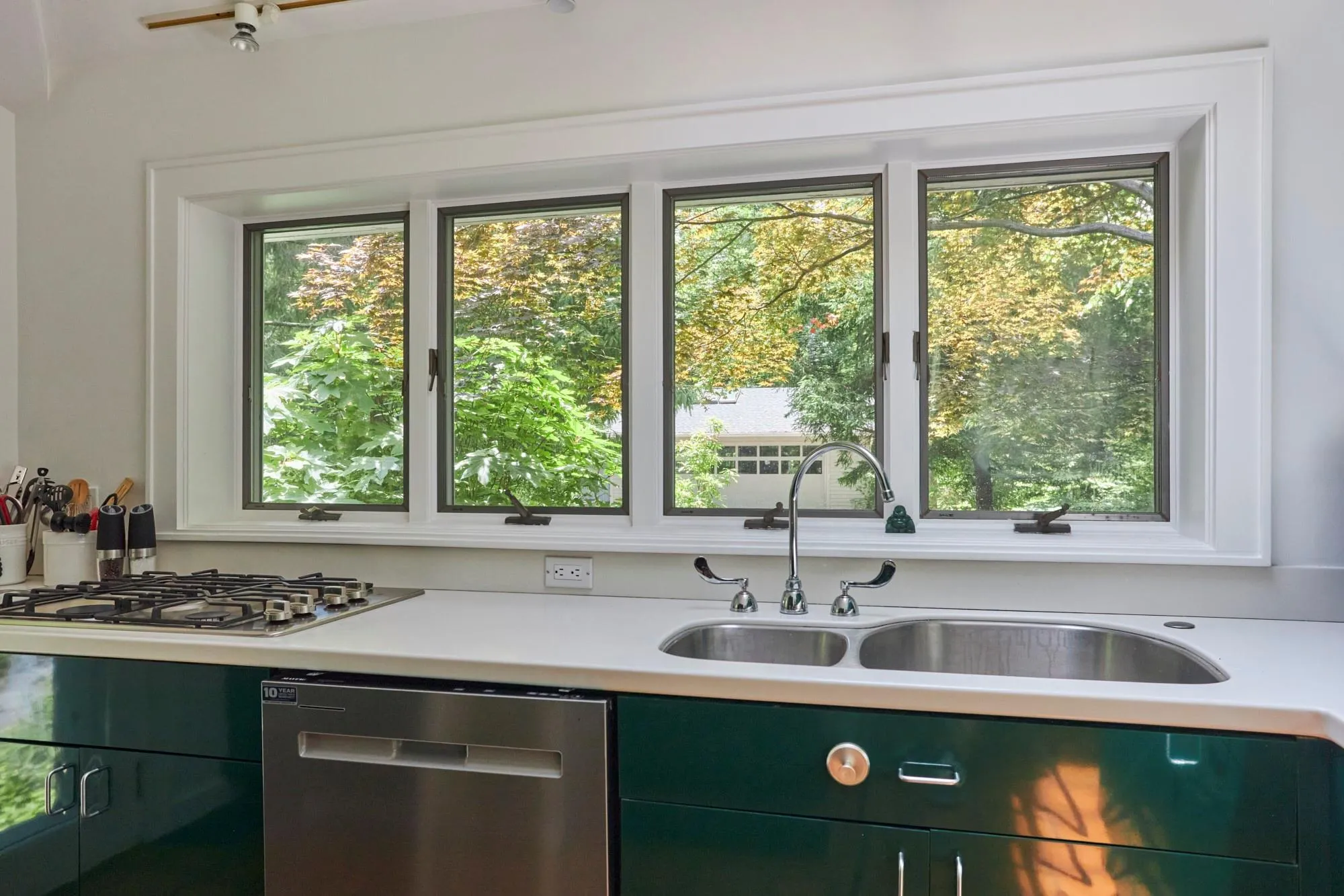 Kitchen with a wealth of natural light, and appliances with stainless steel finishes Kitchen with a wealth of natural light, and appliances with stainless steel finishes