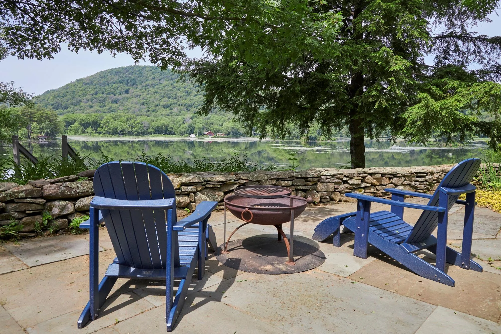 View of patio / terrace with an outdoor fire pit and a mountain view View of patio / terrace with an outdoor fire pit and a mountain view