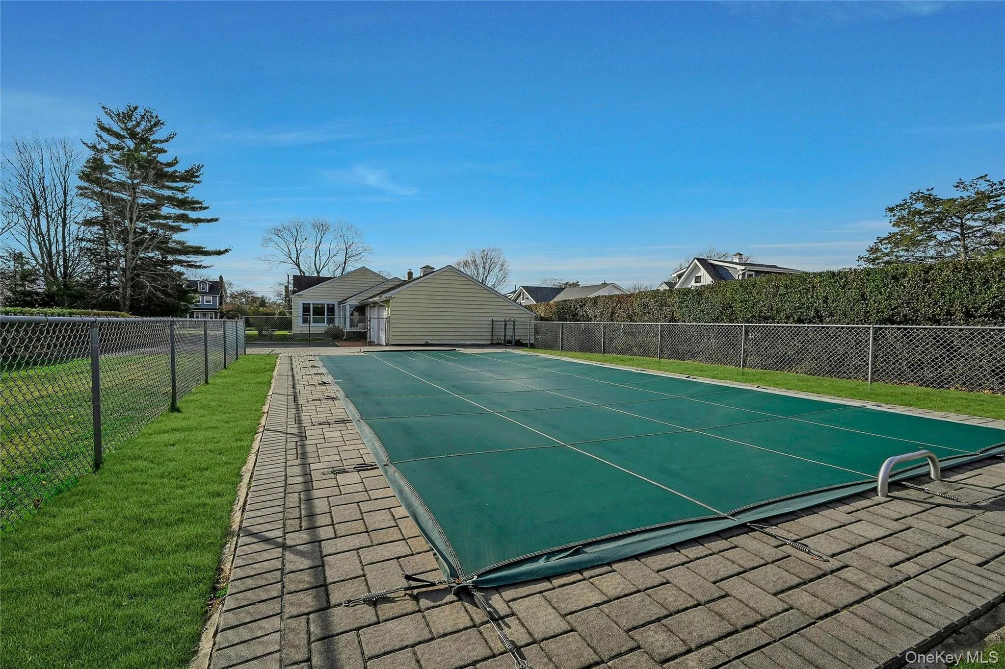 View of pool featuring a yard and fence View of pool featuring a yard and fence