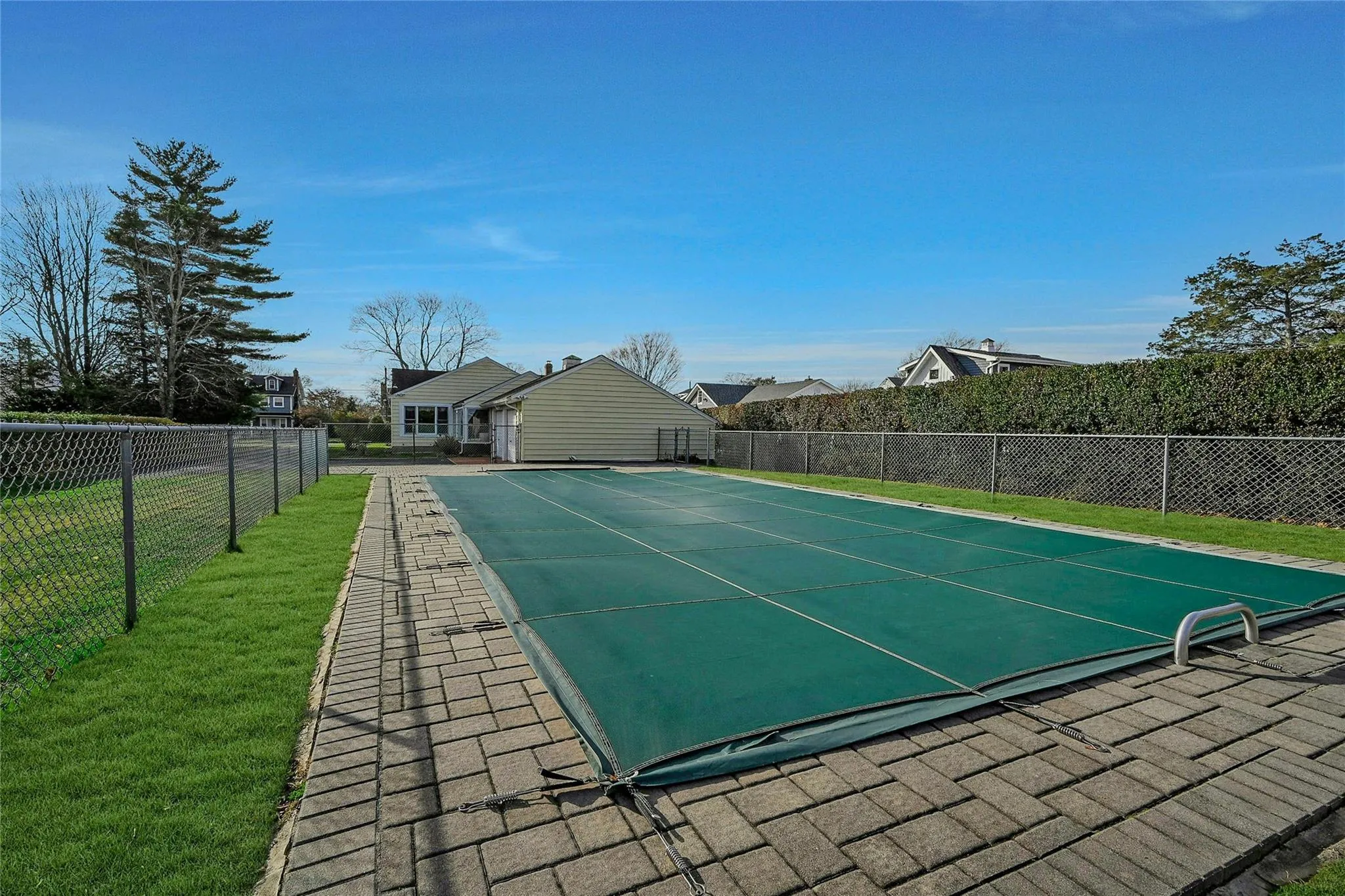 View of pool featuring a yard and fence View of pool featuring a yard and fence