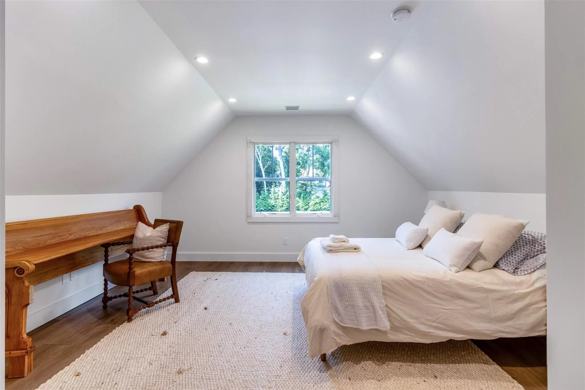 Bedroom featuring baseboards, lofted ceiling, wood finished floors, and recessed lighting Bedroom featuring baseboards, lofted ceiling, wood finished floors, and recessed lighting