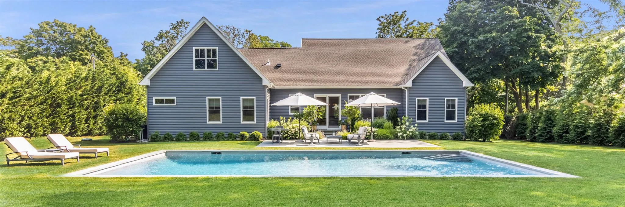 Back of house featuring a patio, roof with shingles, a yard, and an outdoor pool Back of house featuring a patio, roof with shingles, a yard, and an outdoor pool