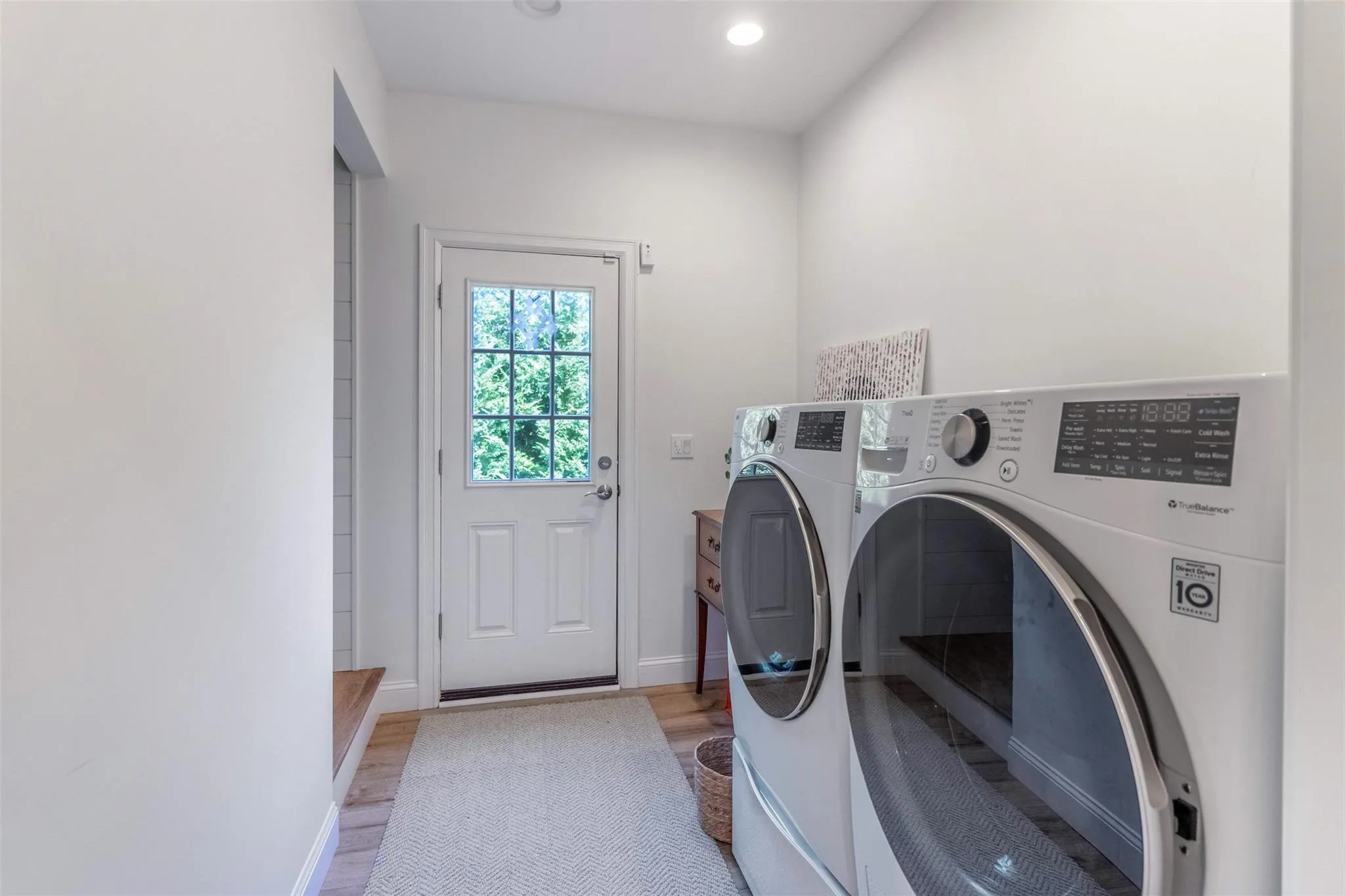 Laundry room with washer and clothes dryer, recessed lighting, baseboards, light wood-style flooring, and laundry area Laundry room with washer and clothes dryer, recessed lighting, baseboards, light wood-style flooring, and laundry area