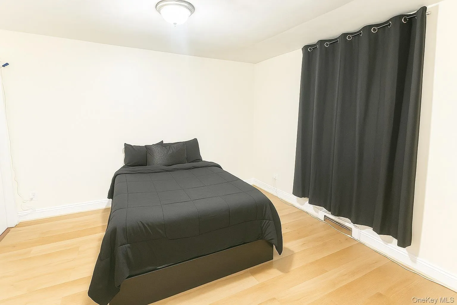 Bedroom with baseboards and light planked floors Bedroom with baseboards and light planked floors